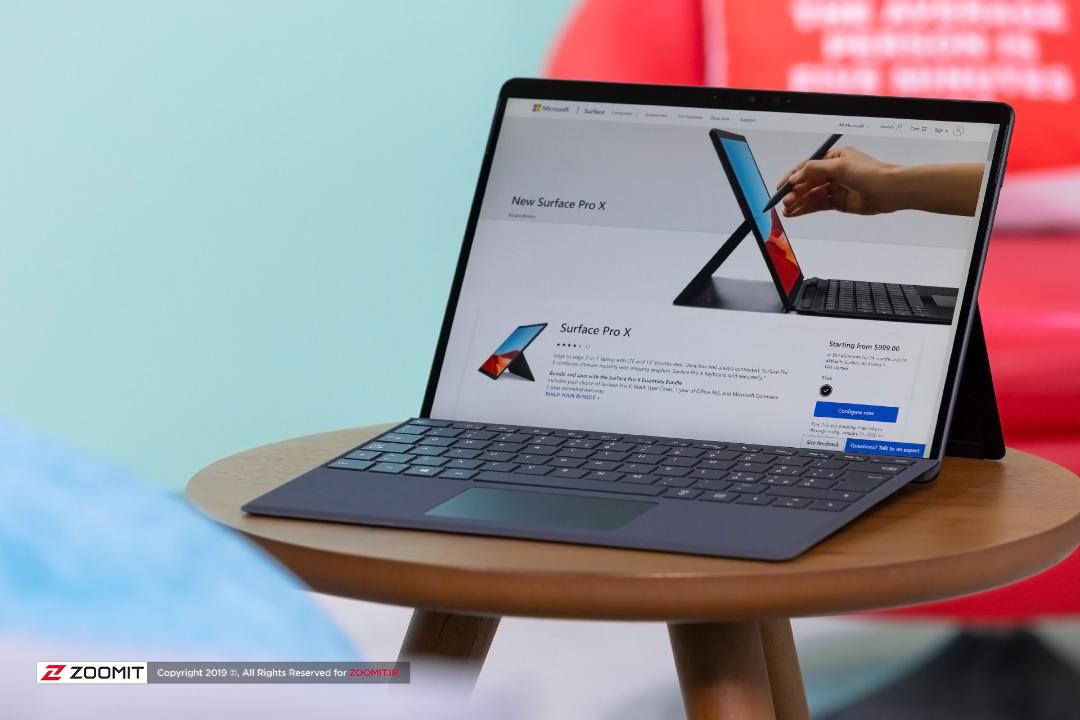 سرفیس پرو ایکس / Microsoft Surface Pro X در سه رخ جلو روی میز چوبی