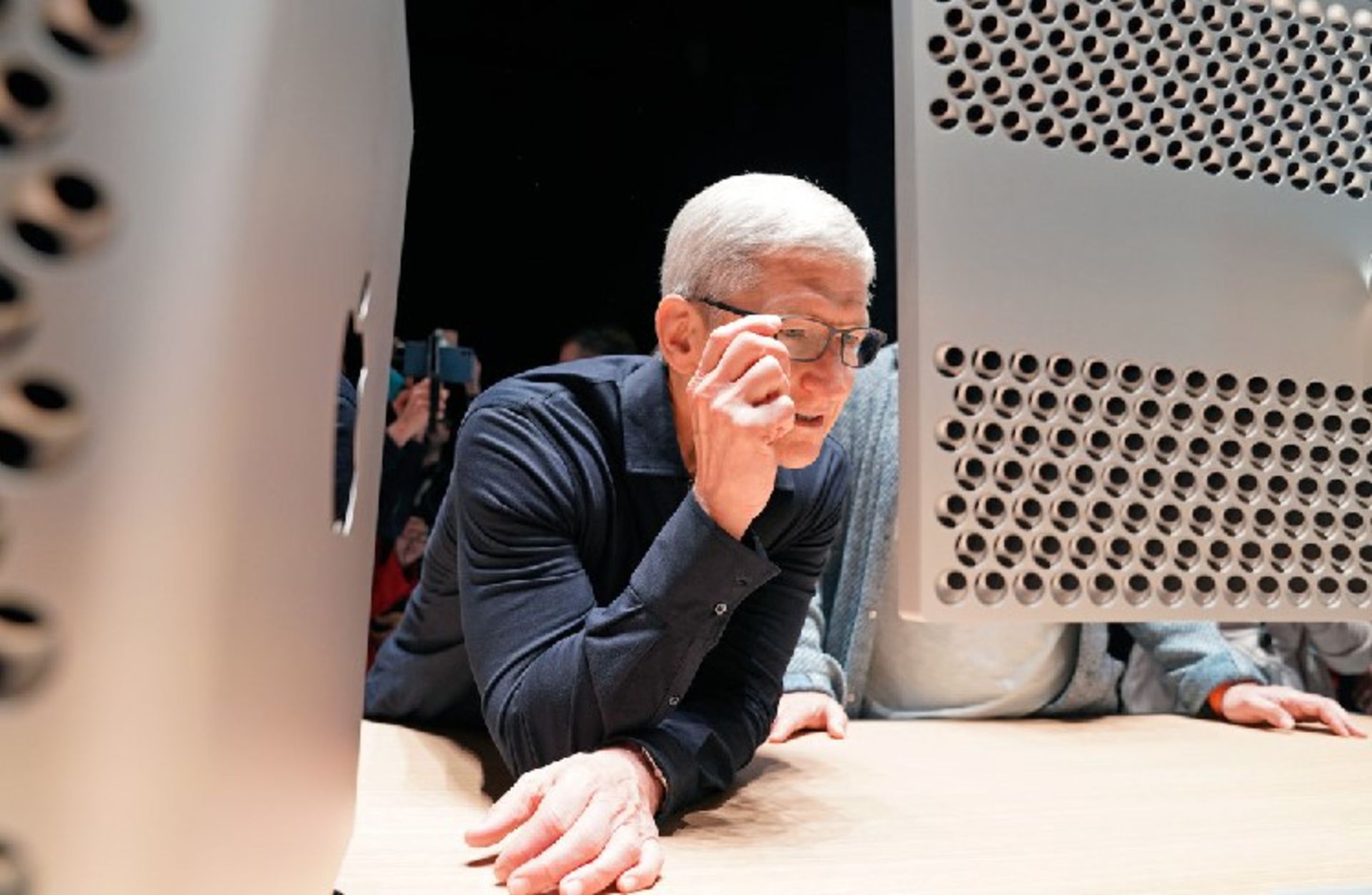 Apple CEO Tim Cook inspects one of the company's new Pro Display XDR monitors, which it unveiled last month