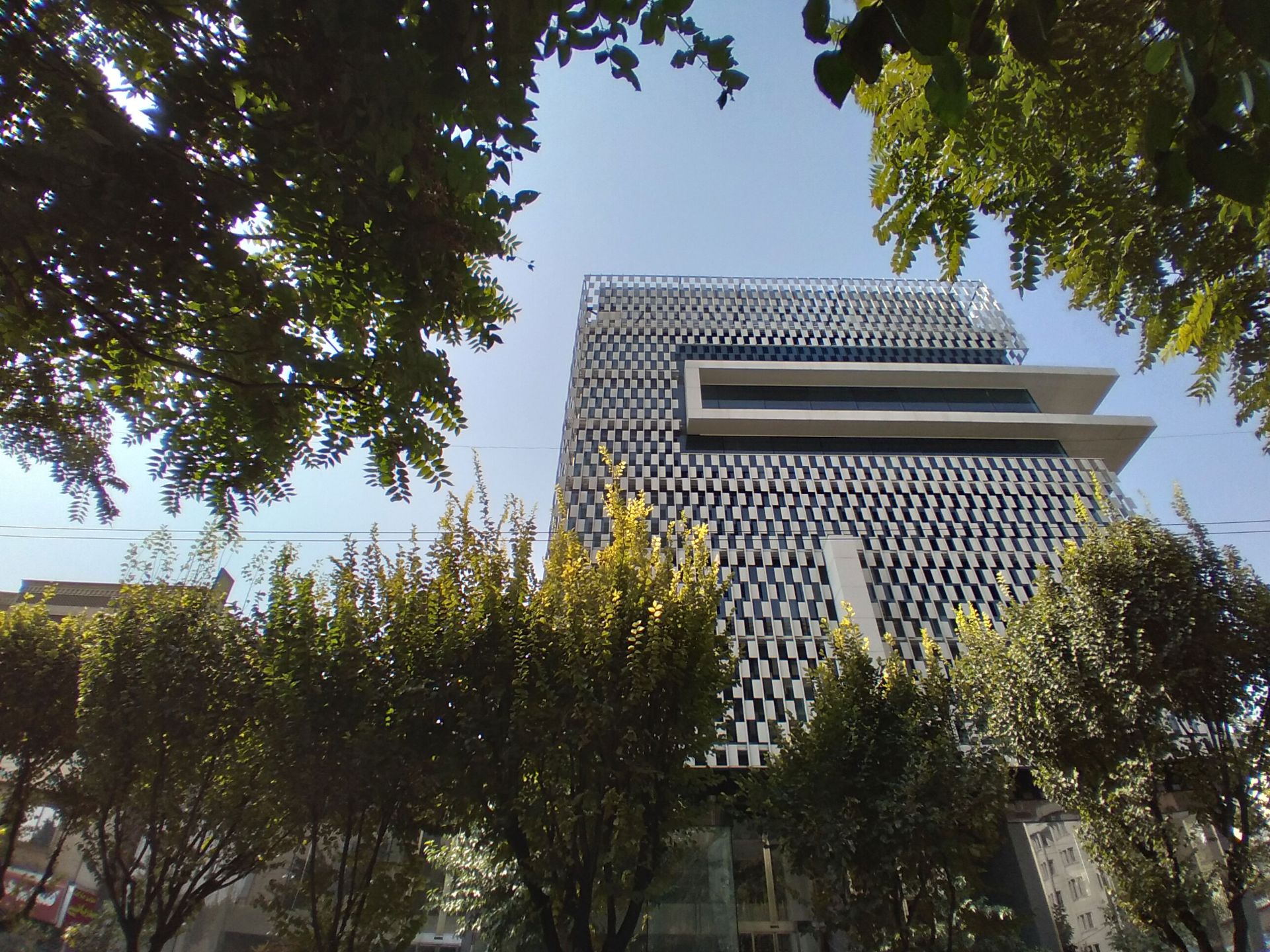 نمونه تصویر دوربین اولتراواید گلکسی A11 - نمای برج در روز از لابه‌لای درختان