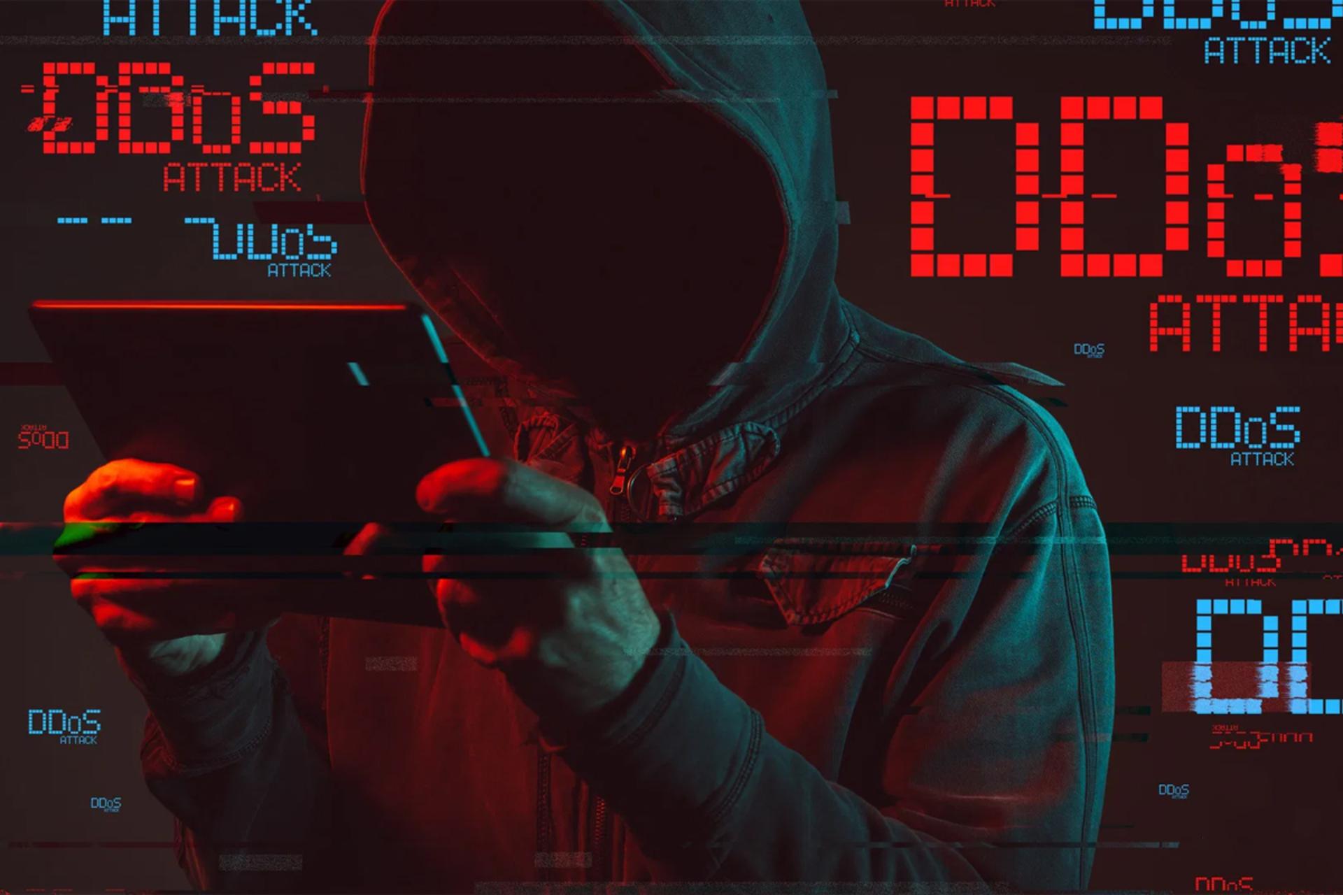عکس هکر با هودی و تبلت حمله دیداس DDoS سایبری
