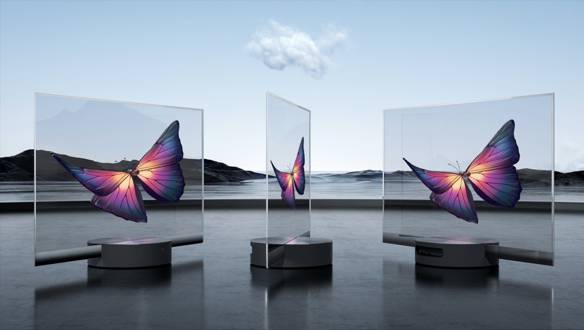 مرجع متخصصين ايران سه دستگاه شيائومي Mi TV Lux OLED Transparent Edition از جلو و نيم رخ در فضاي باز آسمان آبي