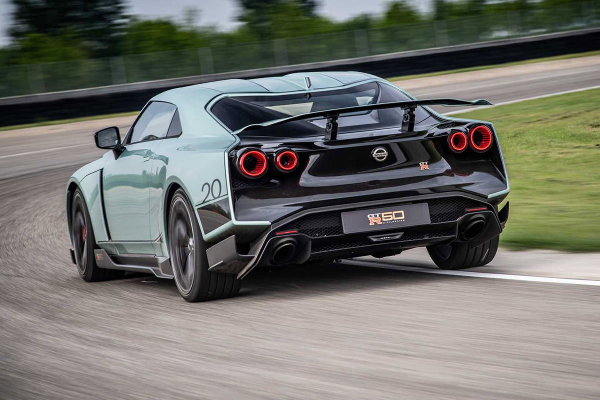 نمای عقب خودرو اسپرت نیسان جی تی آر 50 / Nissan GT-R50 در پیست با منظره آسمان ابری