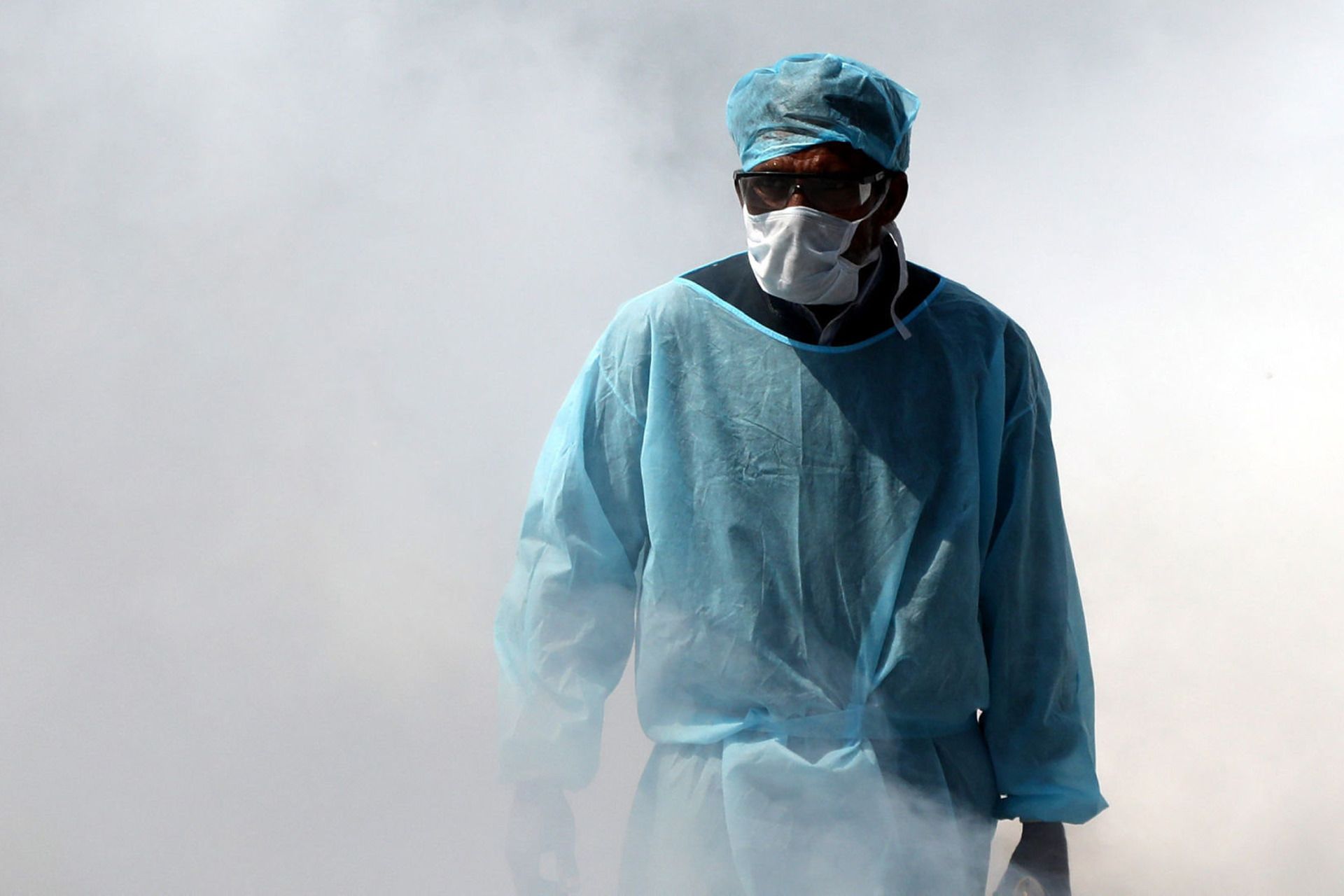 مرد پرستار با لباس آبی و ماسک مخصوص ویروس کرونا / کووید 19