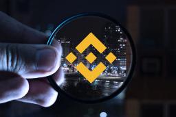 لوگو زرد صرافی رمزارز بایننس / Binance در دست