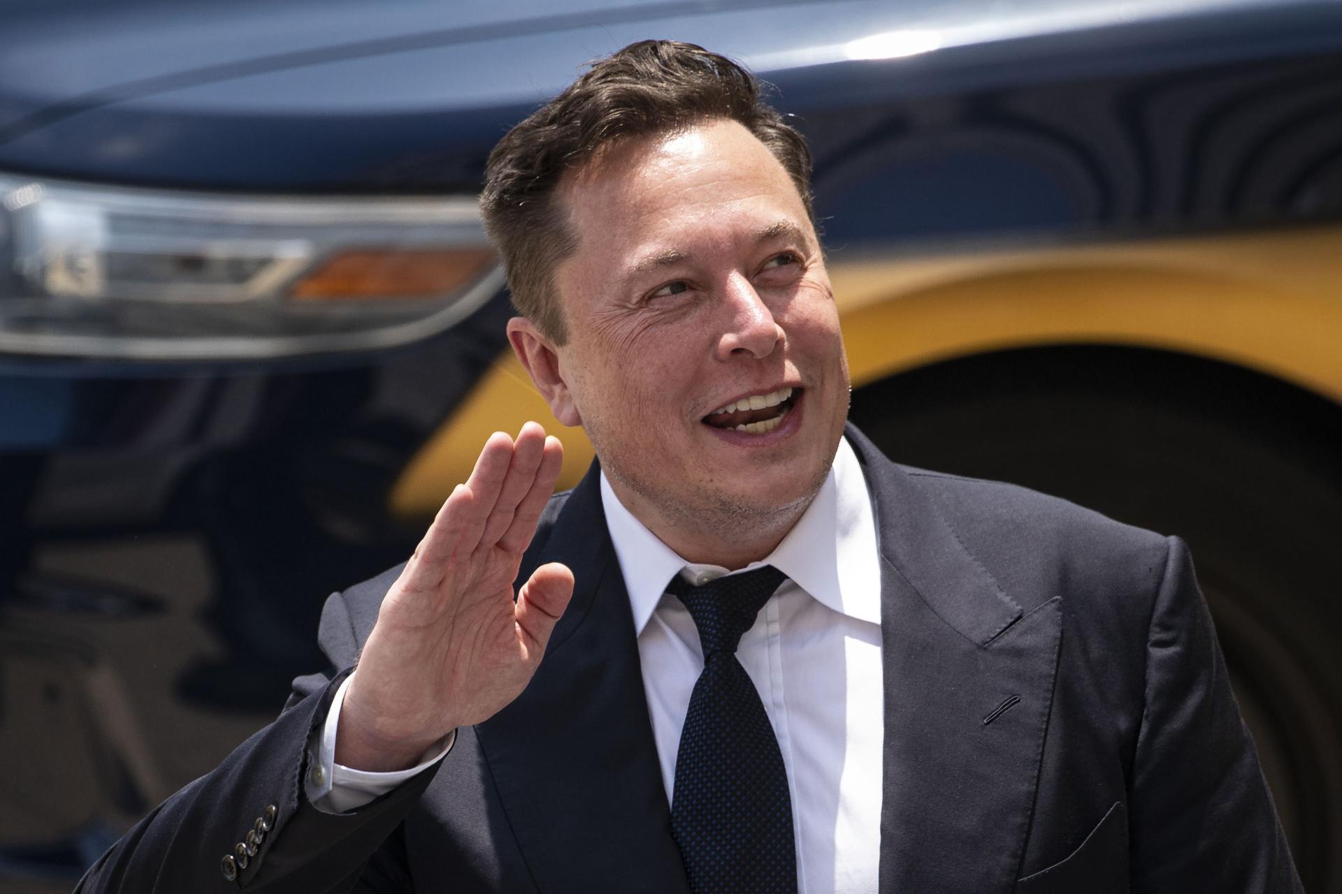 لبخند ایلان ماسک Elon Musk با کت شلوار مشکی و دست راست