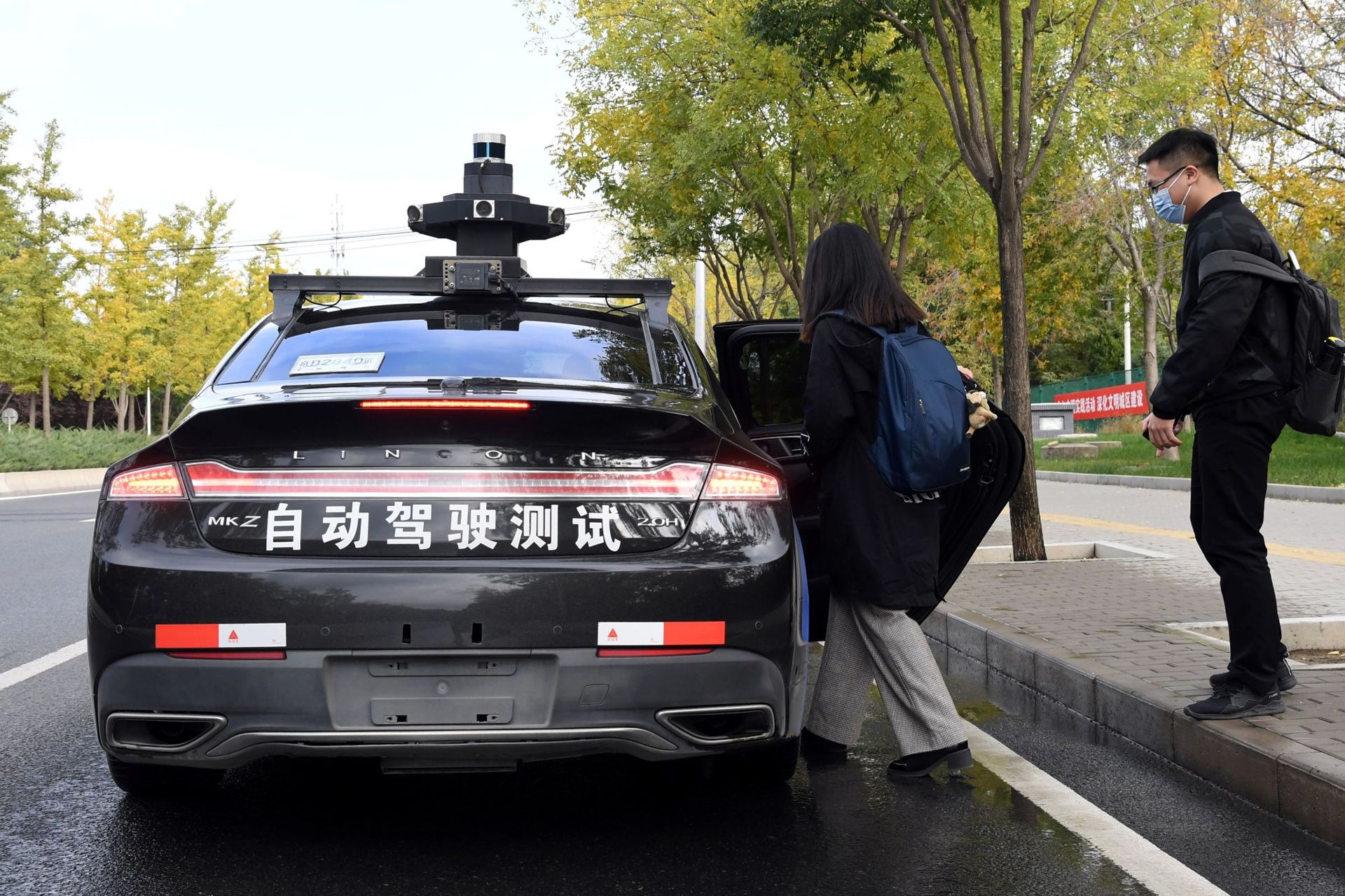 دختر در حال ورود به ربوتاکسی بایدو خودرو مشکی خیابان