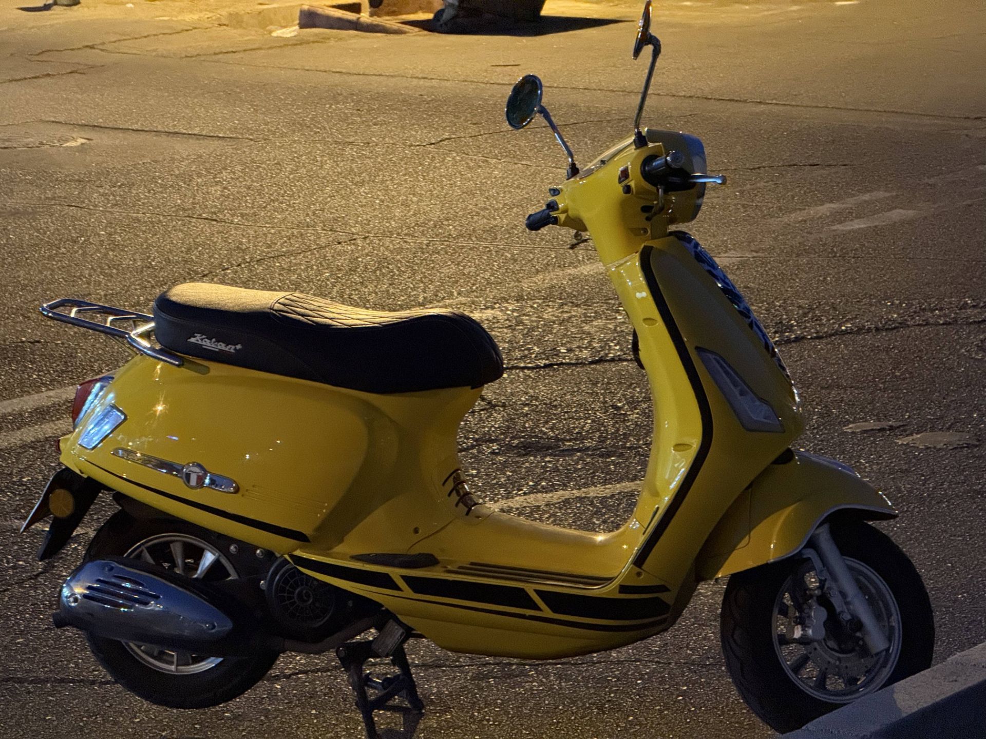 Yellow motorcycle in the dark - iPhone 16 Pro telephoto camera