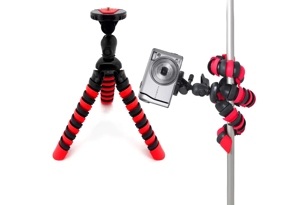 A red and black spider tripod holding a camera