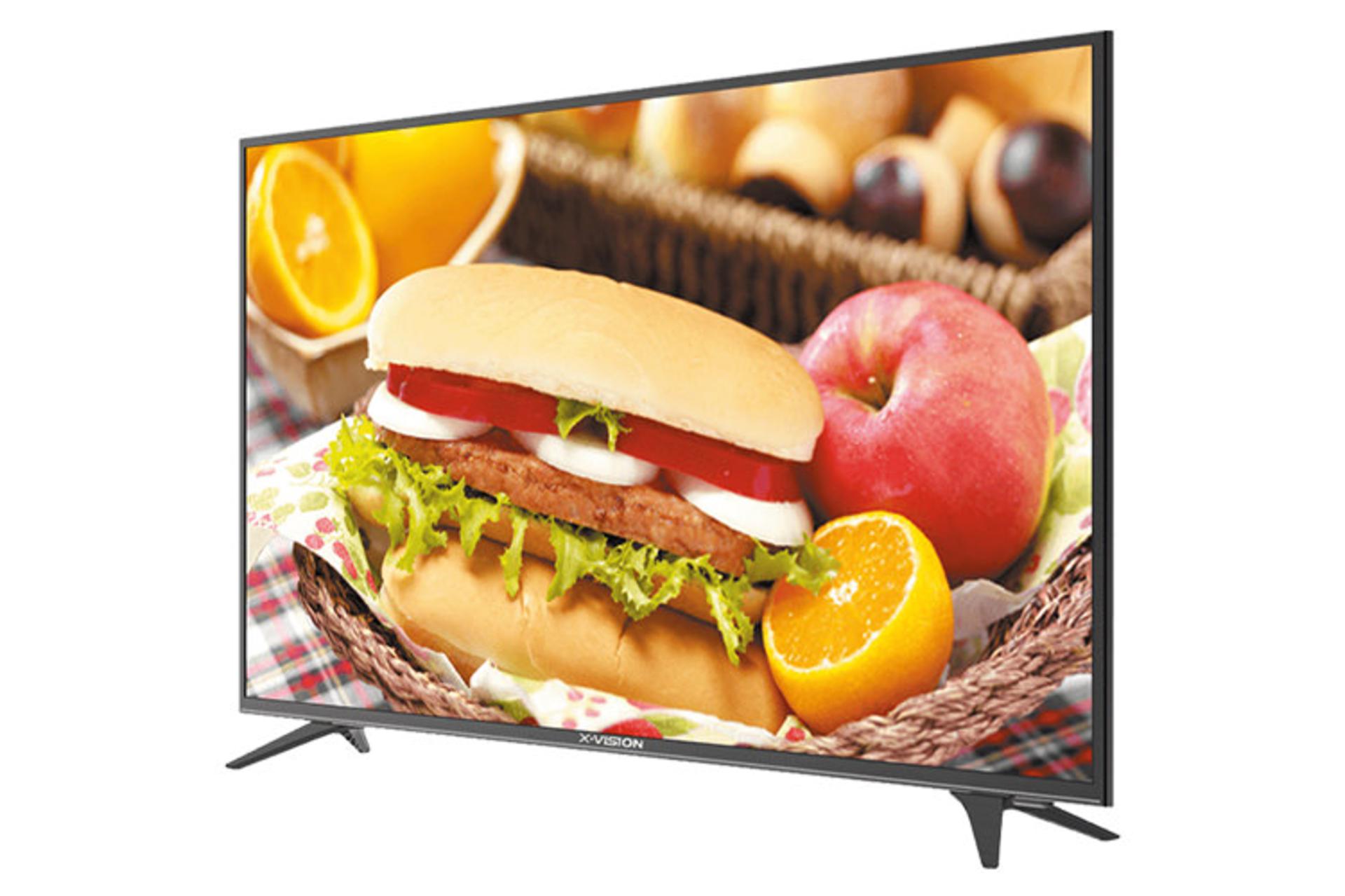 نمای نیم رخ تلویزیون ایکس ویژن 32XT520 مدل 32 اینچ با صفحه روشن و روی پایه