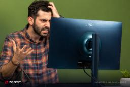 مردی با چهره‌ای عصبی در حال نگاه کردن به پشت مانیتور