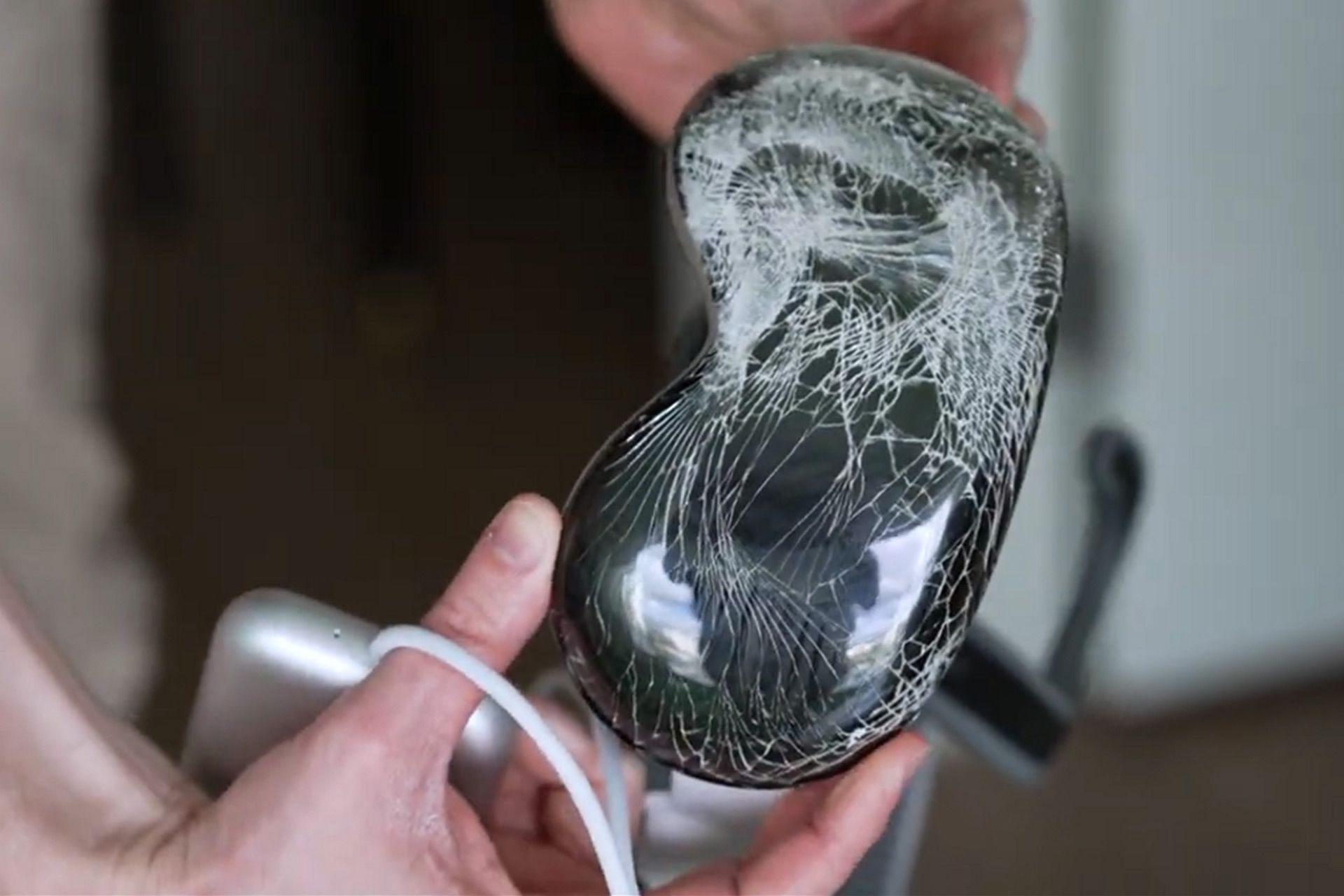 شیشه‌ی شکسته‌ی اپل ویژن پرو در دستان یک شخص