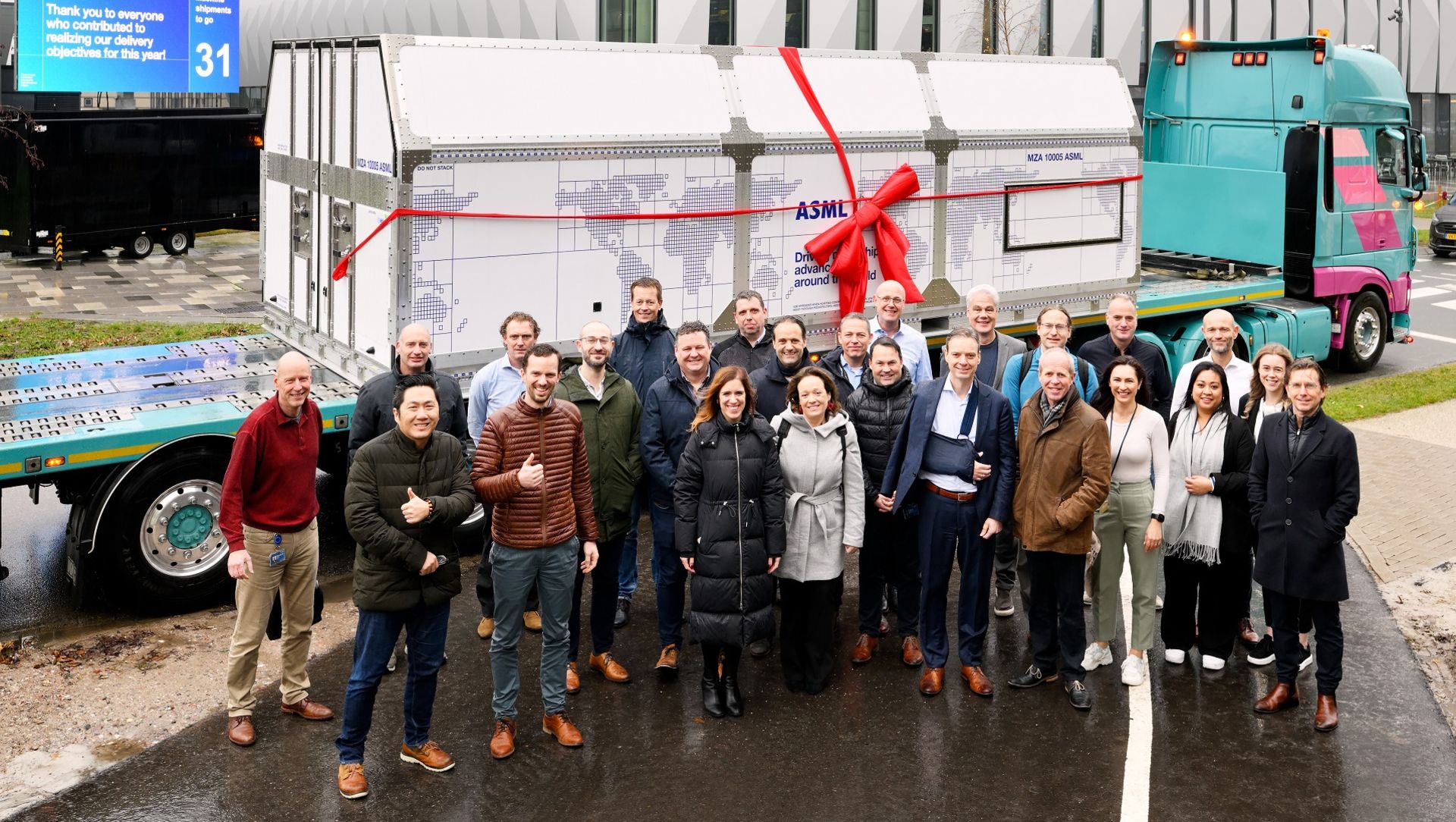 Asml employees in front of the device inside the shipping container