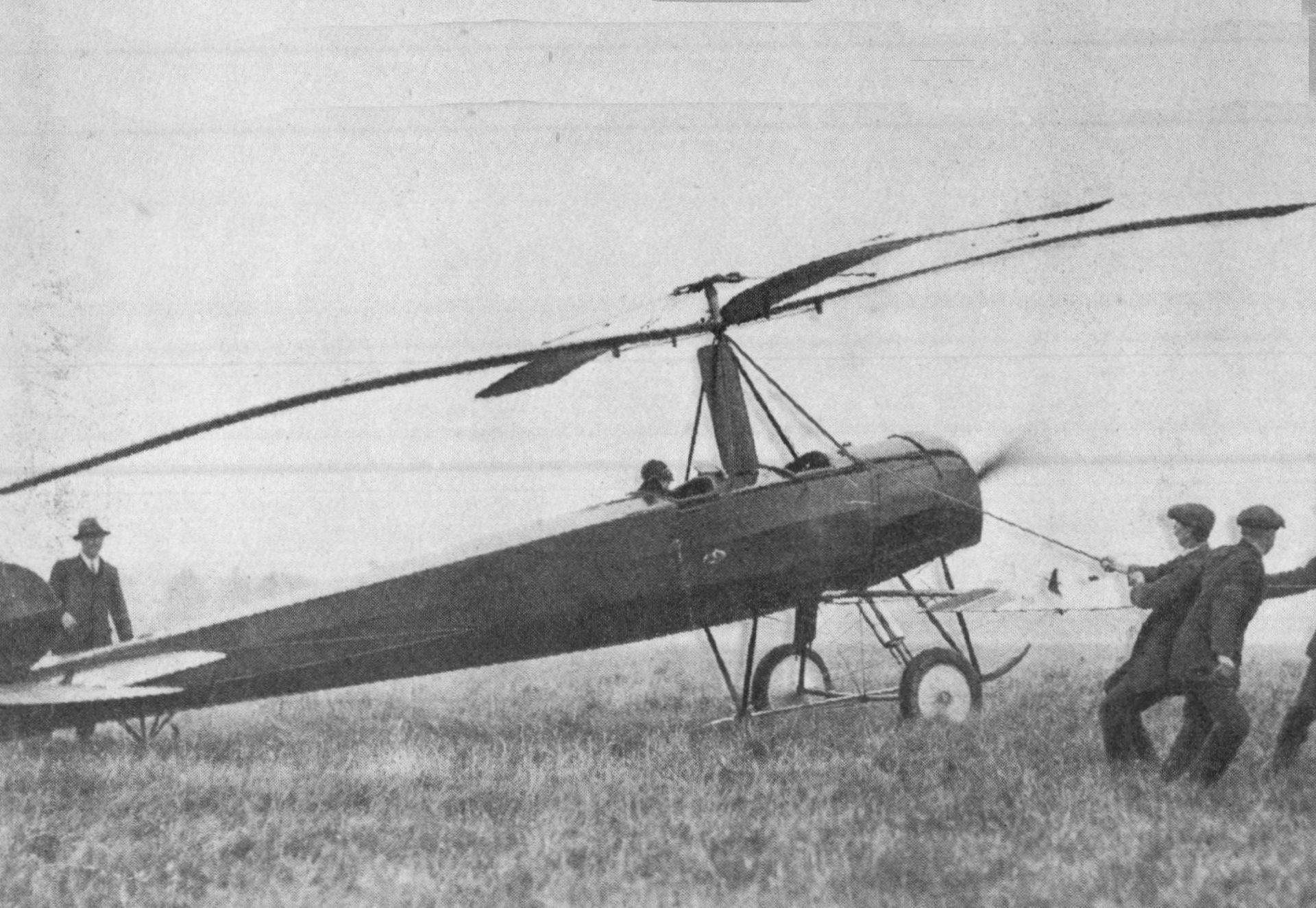 A picture of a man next to an autogyro