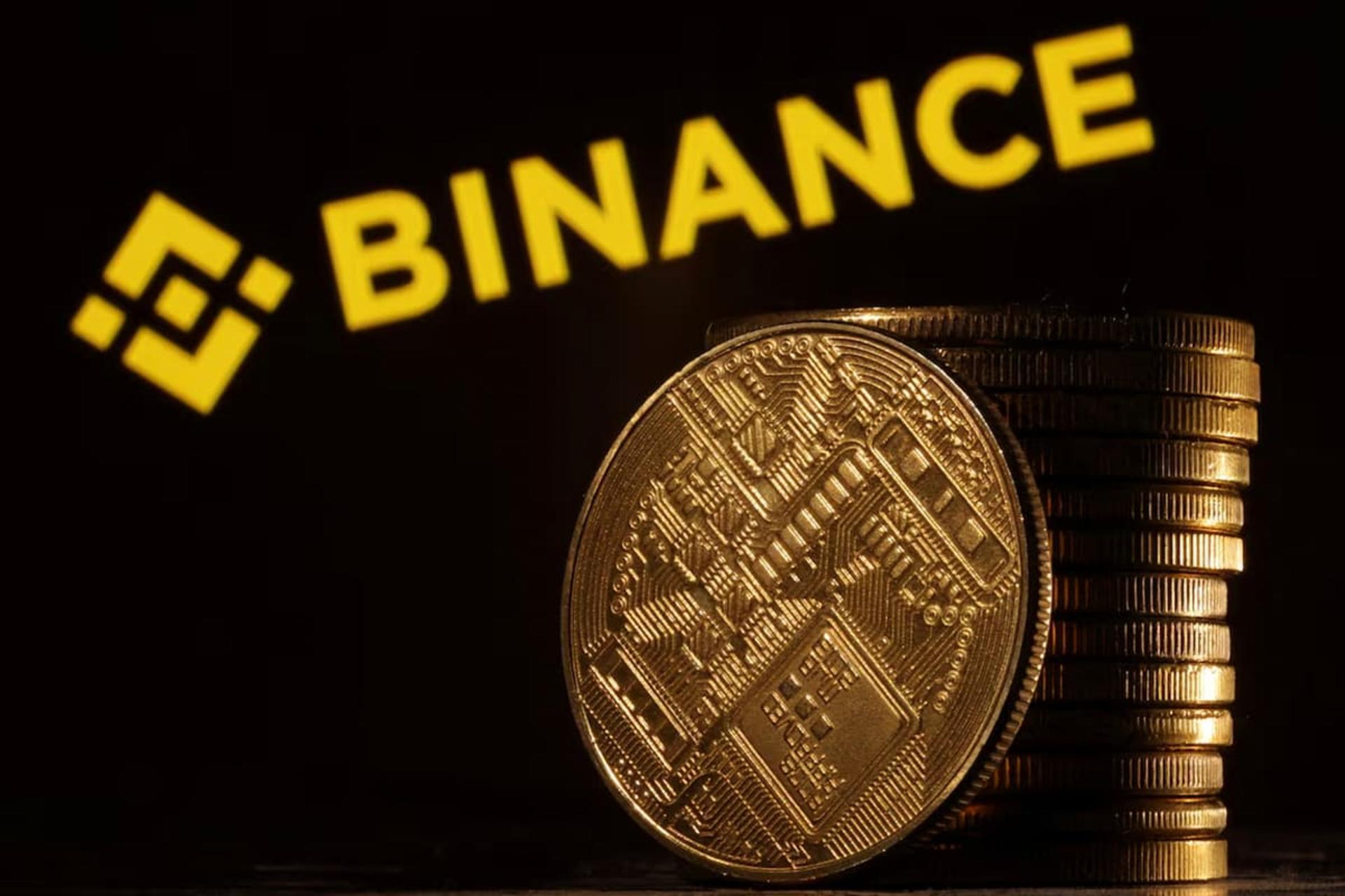 لوگو بایننس / Binance در کنار سکه بیت کوین