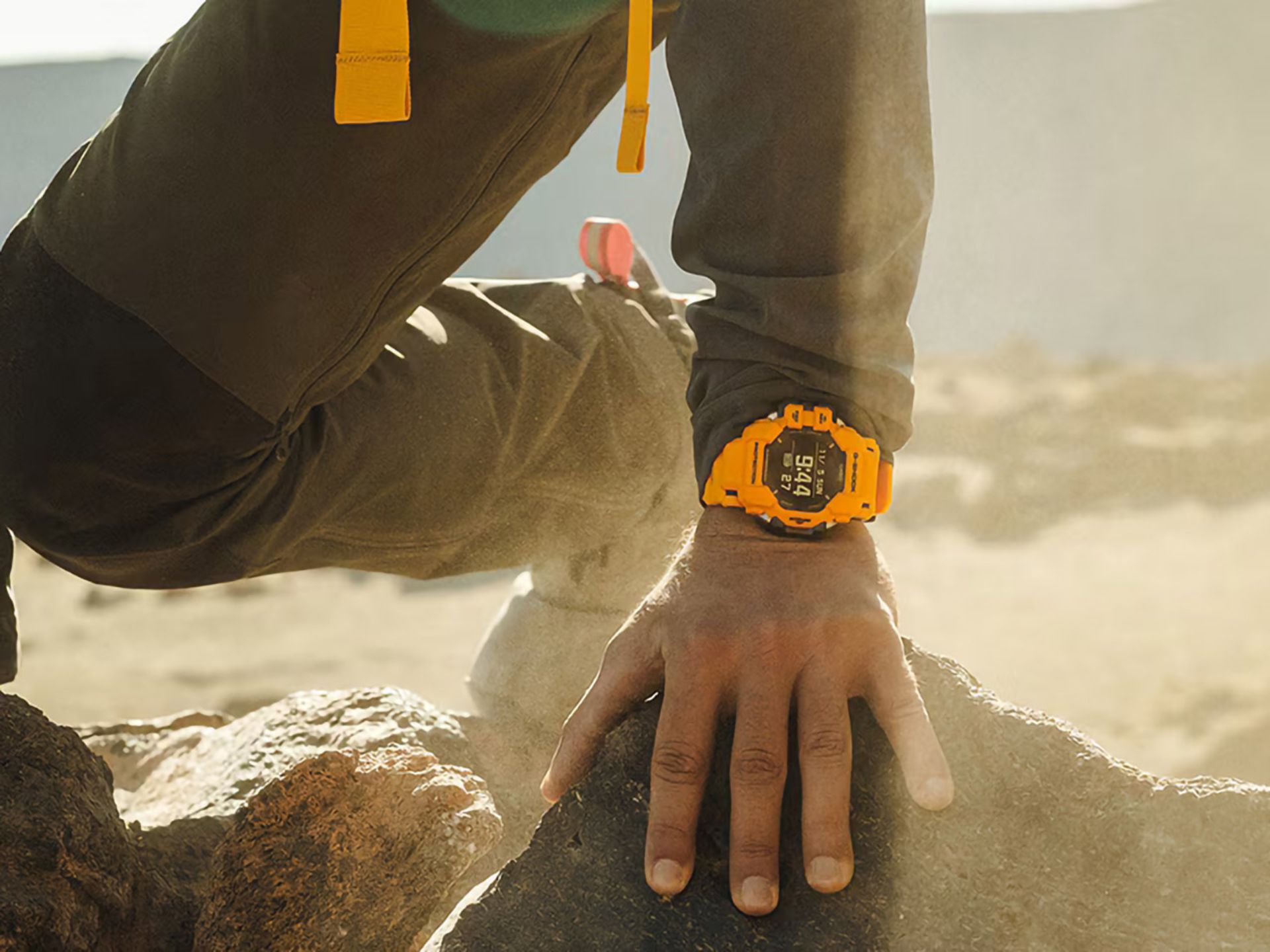 casio-gshock-military-watches-hand-on-rock-orange-watch-color