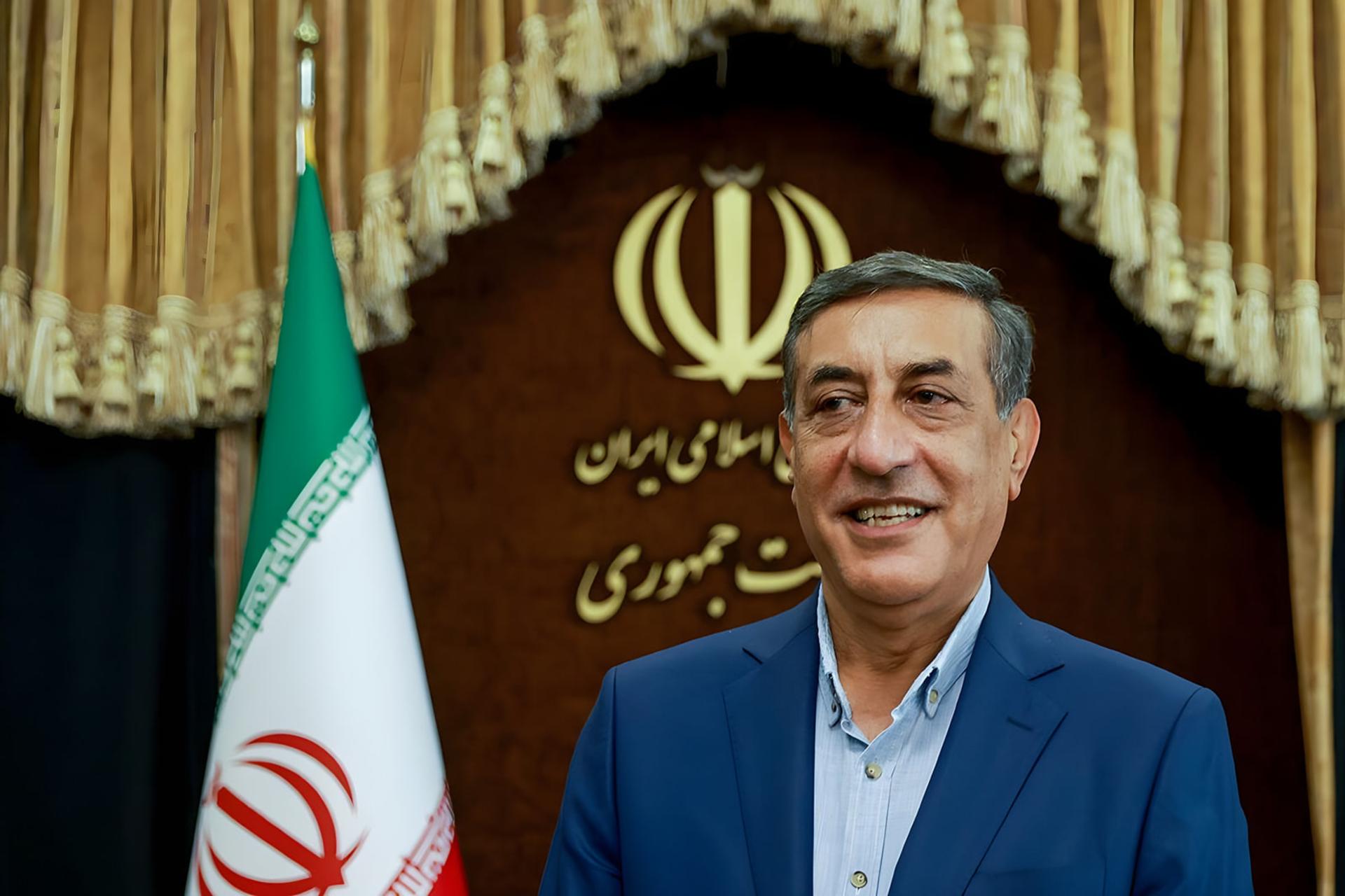 معاون اجرایی رئیس‌جمهور در مقابل پرچم ایران