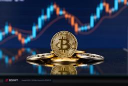 سکه طلایی بیت‌کوین (Bitcoin) روی سطحی بازتابنده در مقابل نمودار قیمت