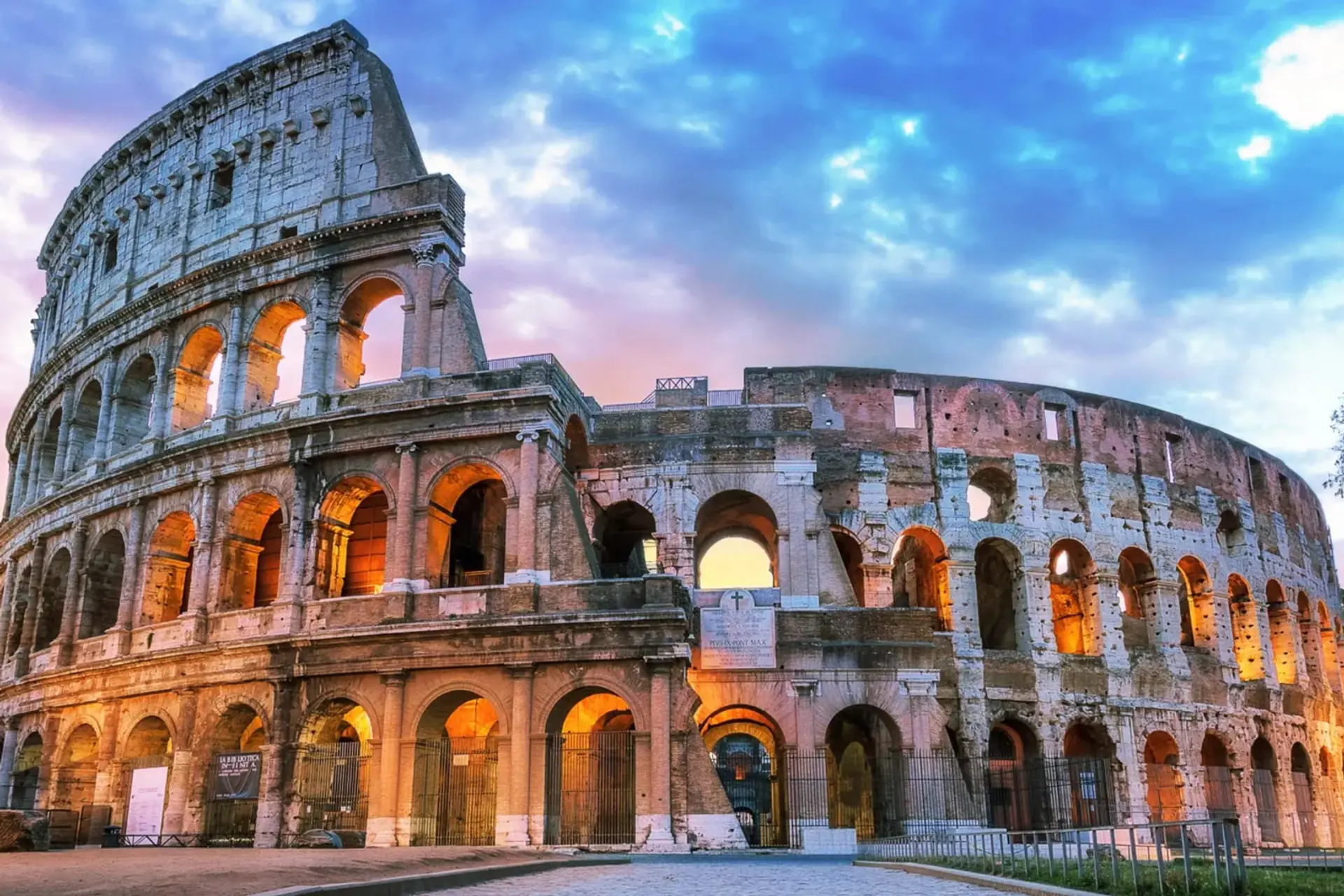 بنای عظیم کولوسئوم (Colosseum) در شهر رم با قوس‌های سنگی و نورپردازی شبانه