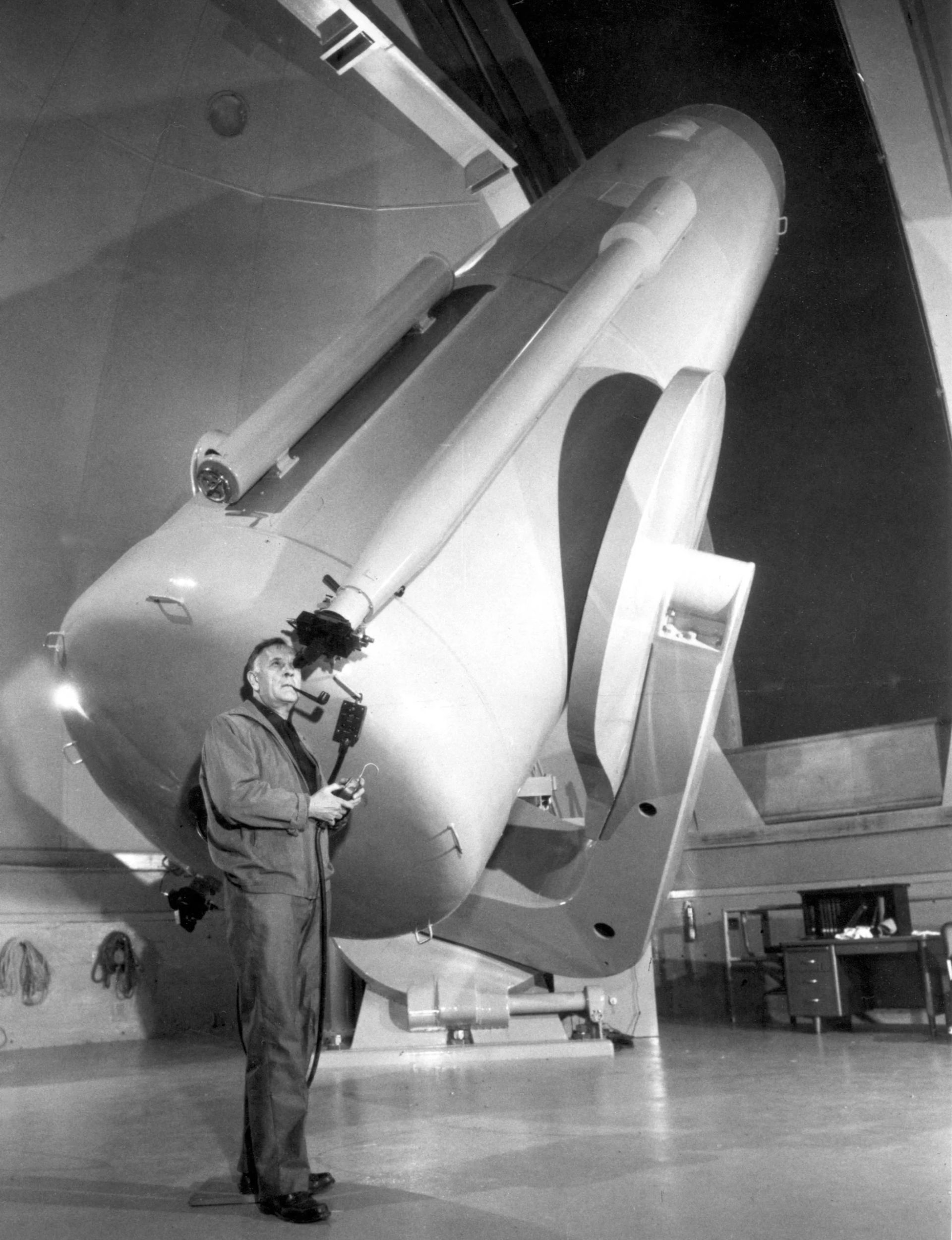 Edwin Hubble next to the telescope