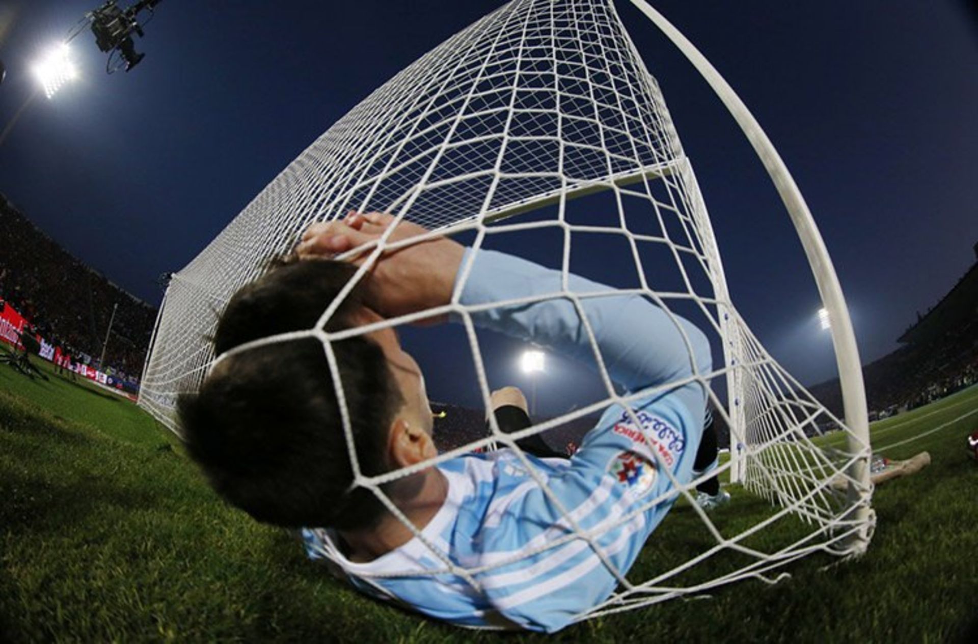 6 argentinas lionel messi falls in the net during the copa america 2015 final soccer match against chile at the national stadium in santiago chile s fd8bf