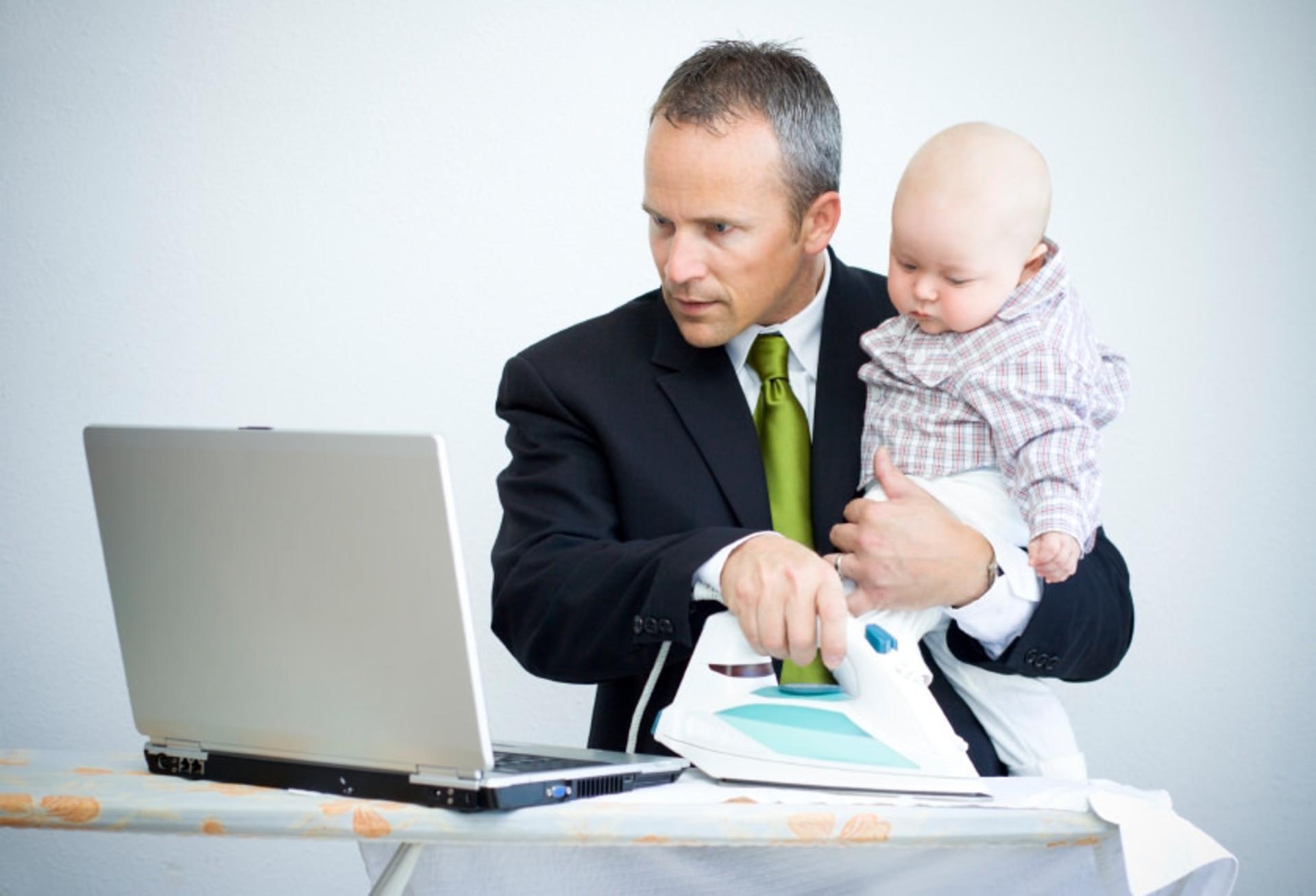 man multitasking with phone iron baby in hand f206b
