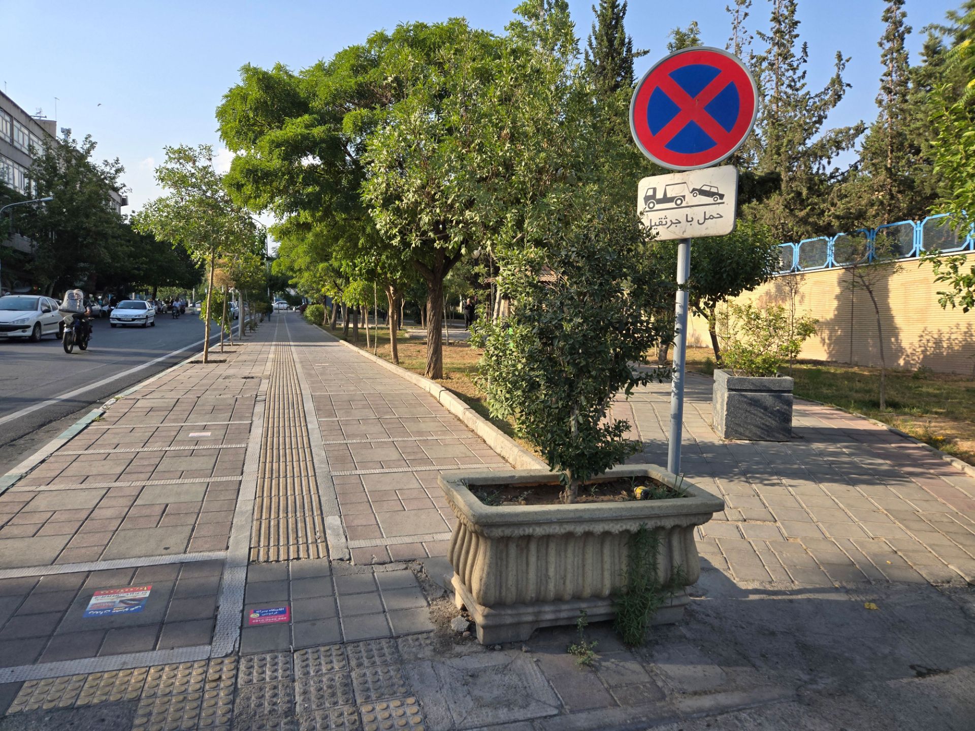 Wide sidewalk next to the park