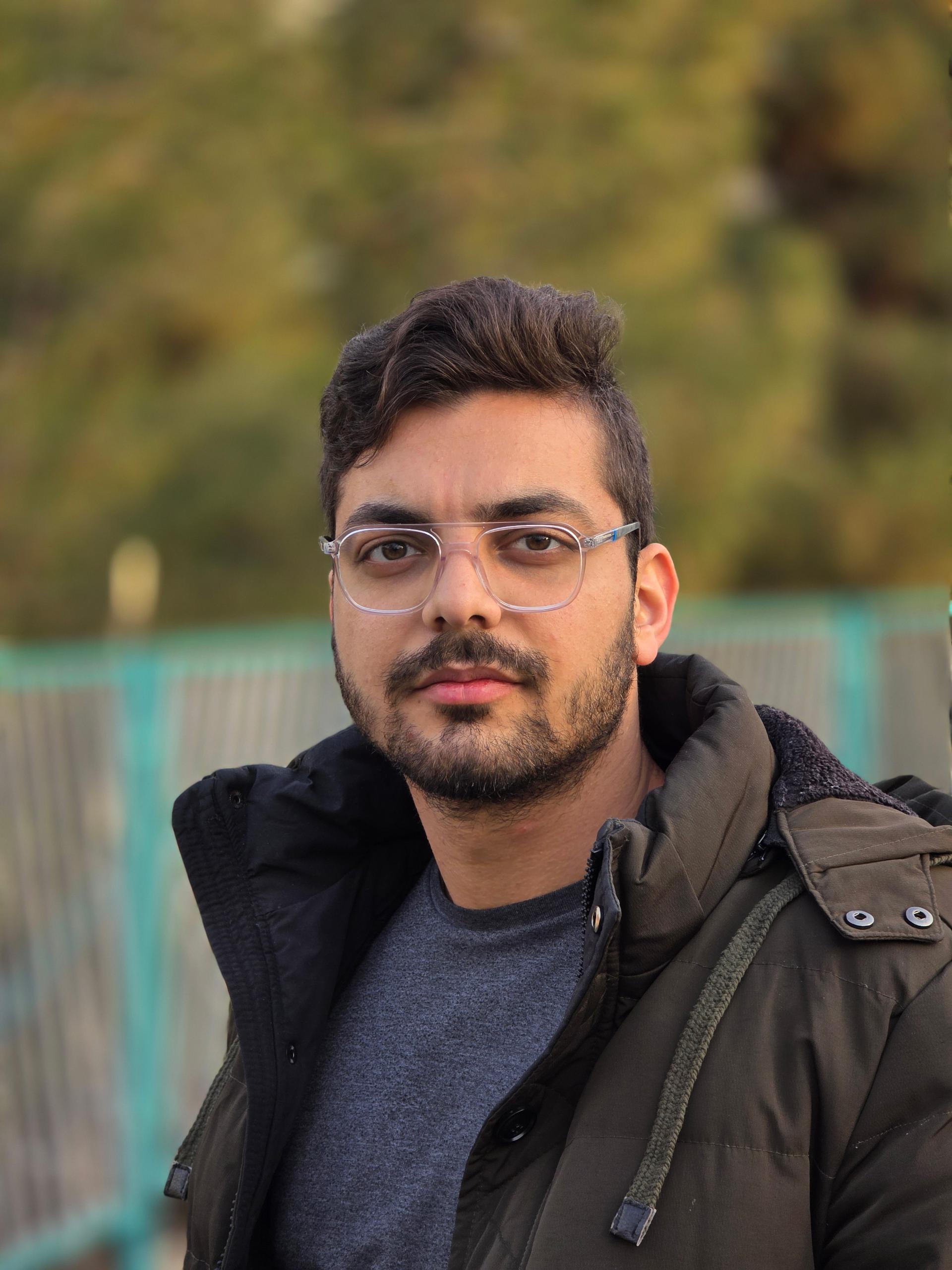 پسری عینکی با کاپشن سبز