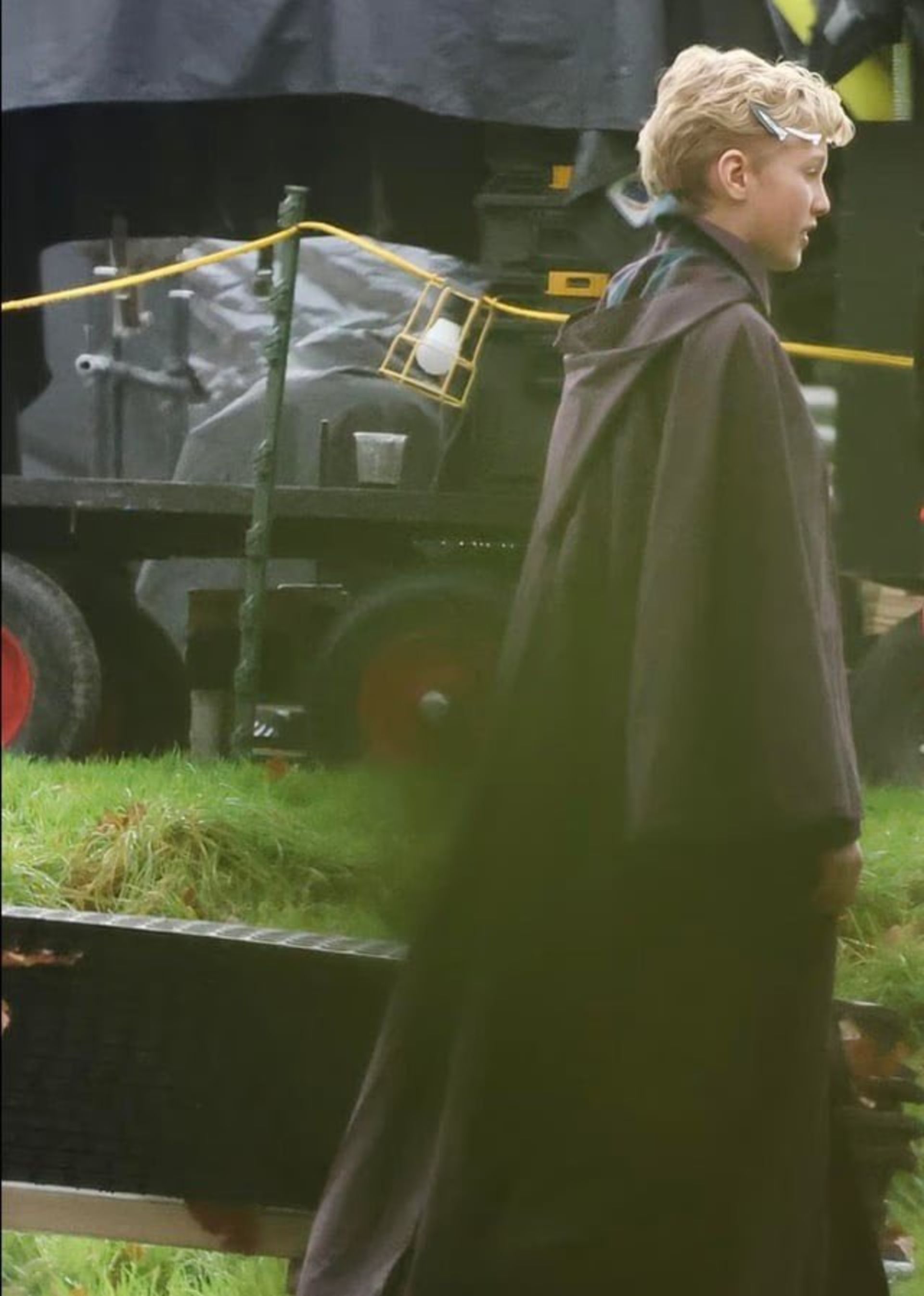 یک پسر نوجوان در پشت‌صحنه‌ی سریال هری پاتر با ردای بنفش