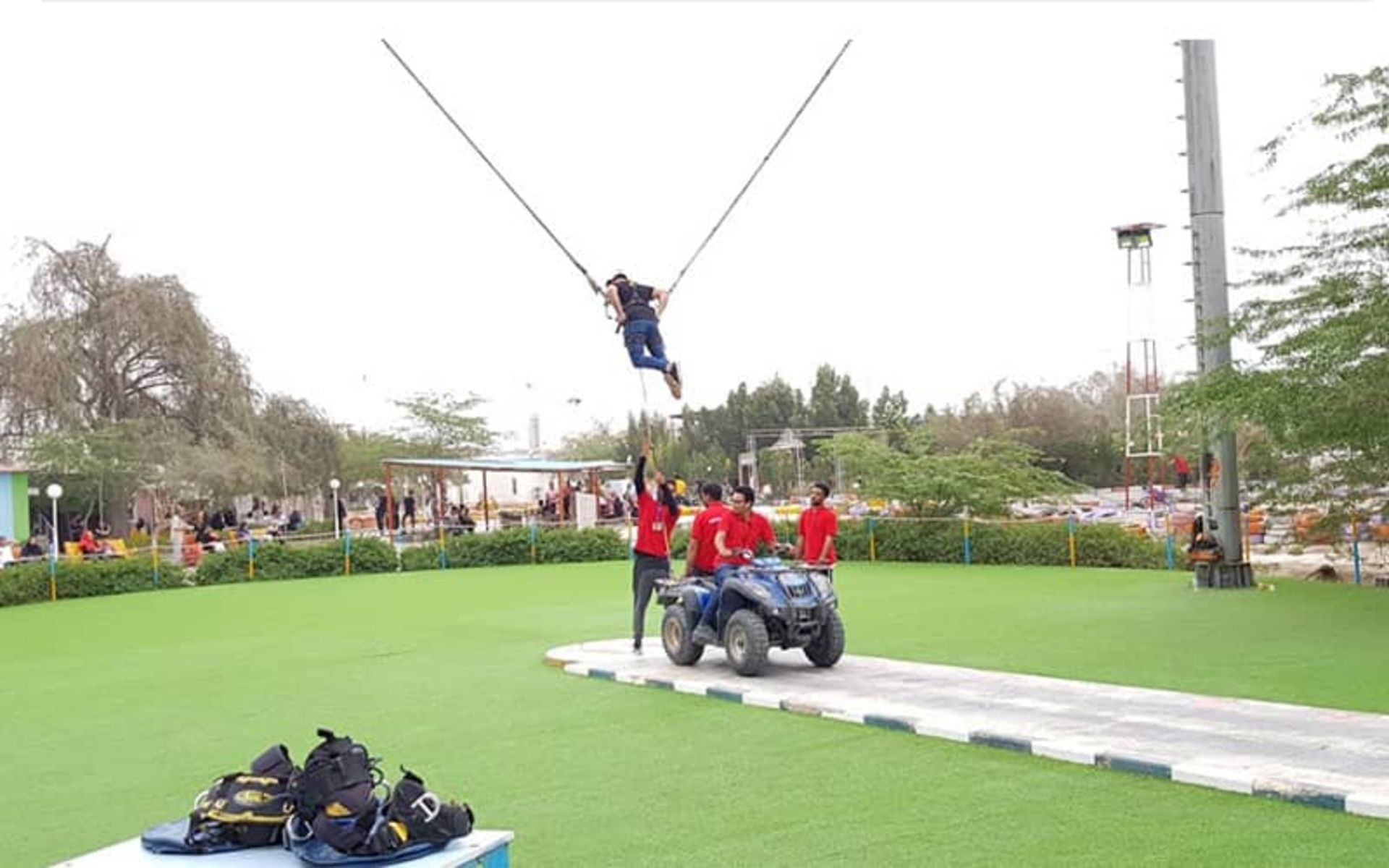 بانجی شوتینگ و سه نفر در کنار یک موتور چهارچرخ