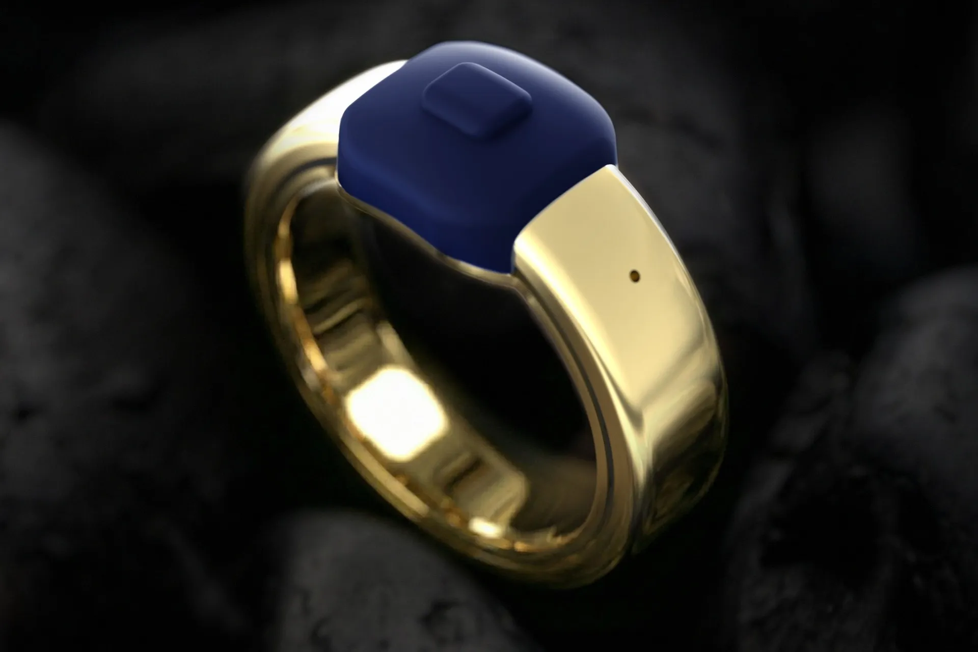 حلقه هوشمند Index 01 رنگ طلایی از نمای بالا روی سنگ