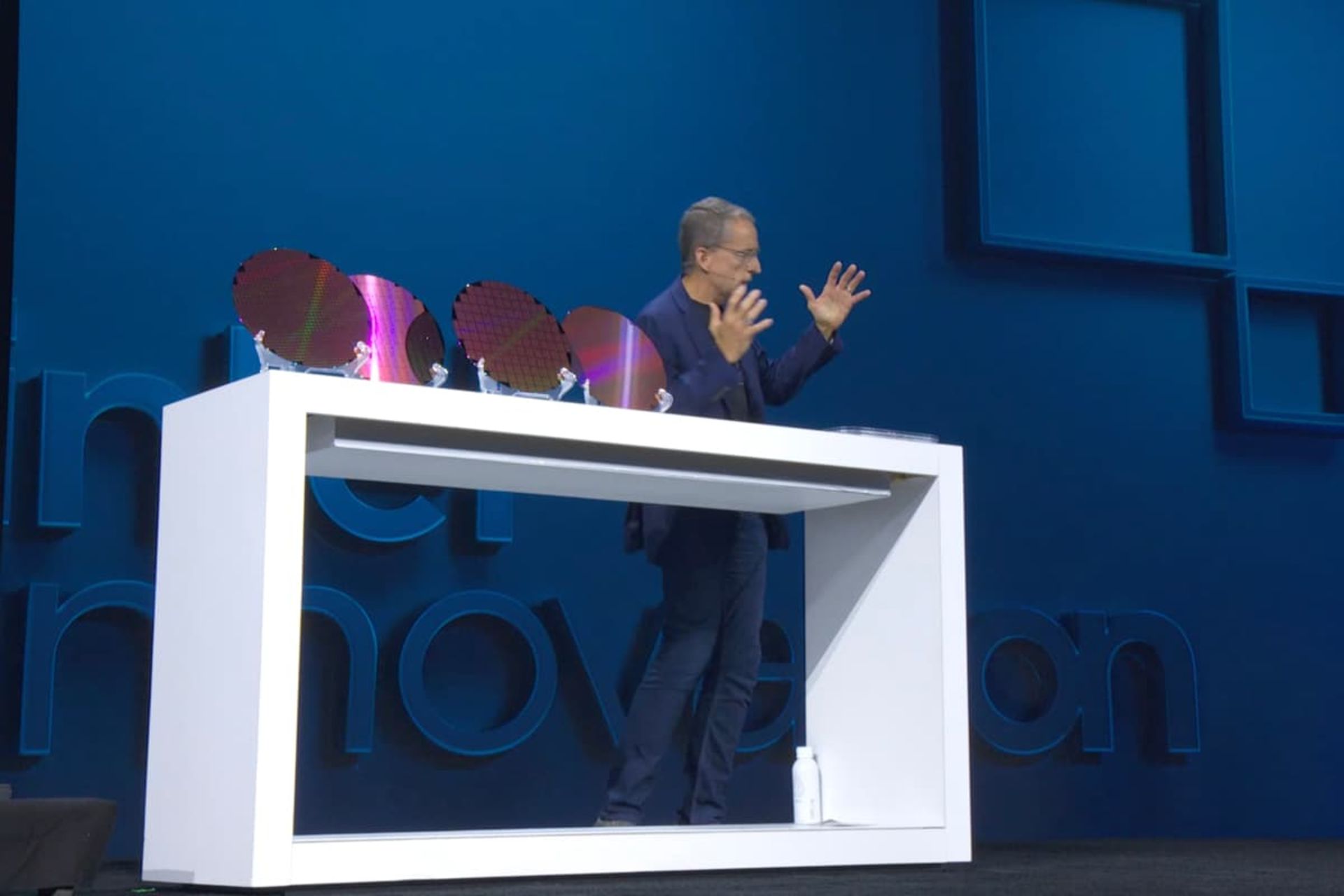 Pat Gelsinger next to a chip wafer at the Intel Innovation 2023 event