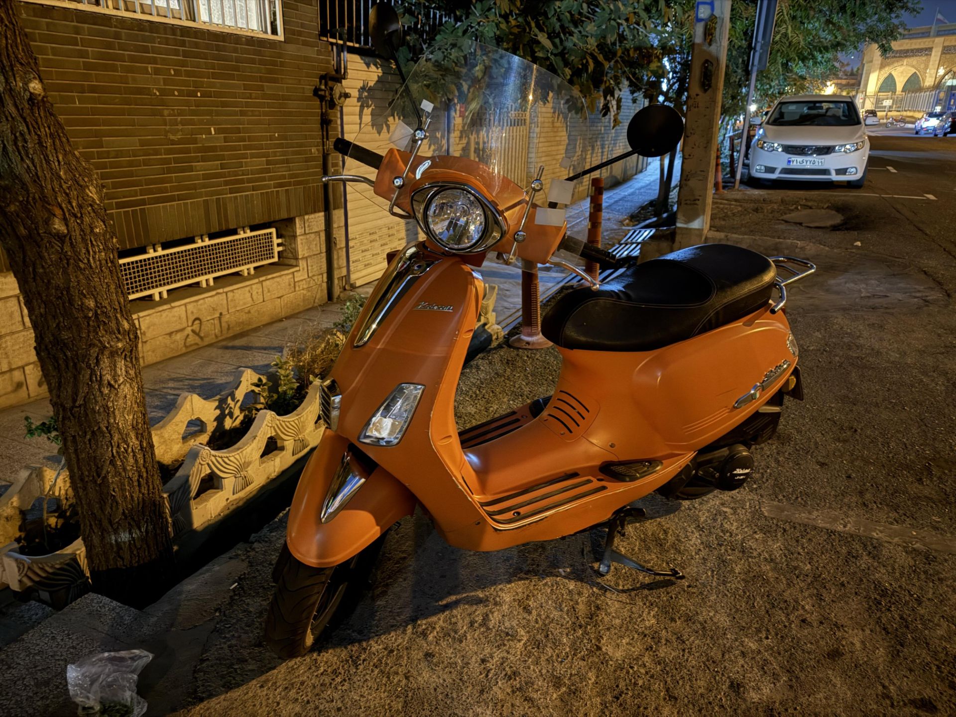 Orange motorcycle - main iPhone 16 Pro camera in the dark