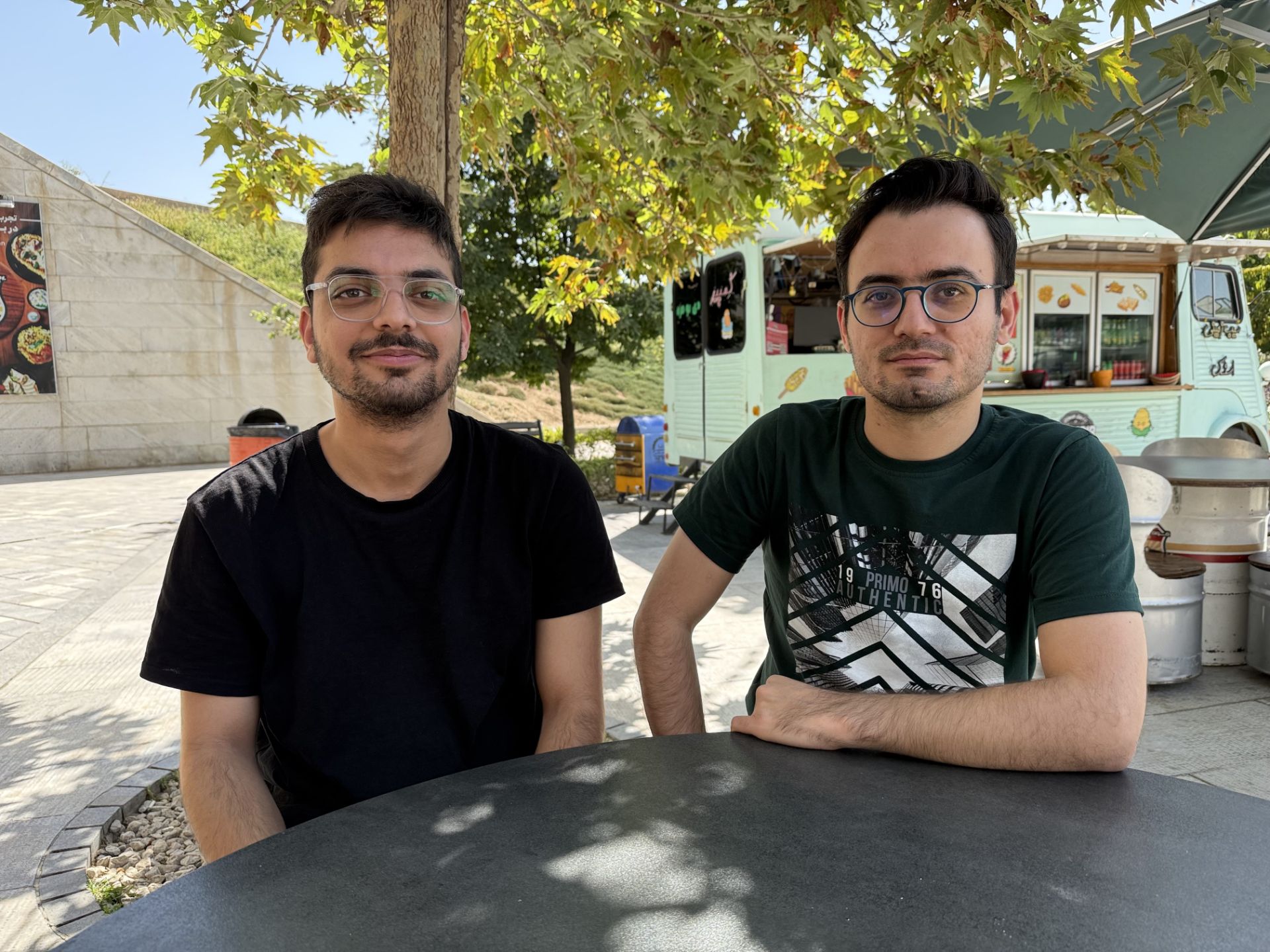 Two young people in the book garden of Tehran - iPhone 16 Pro main camera