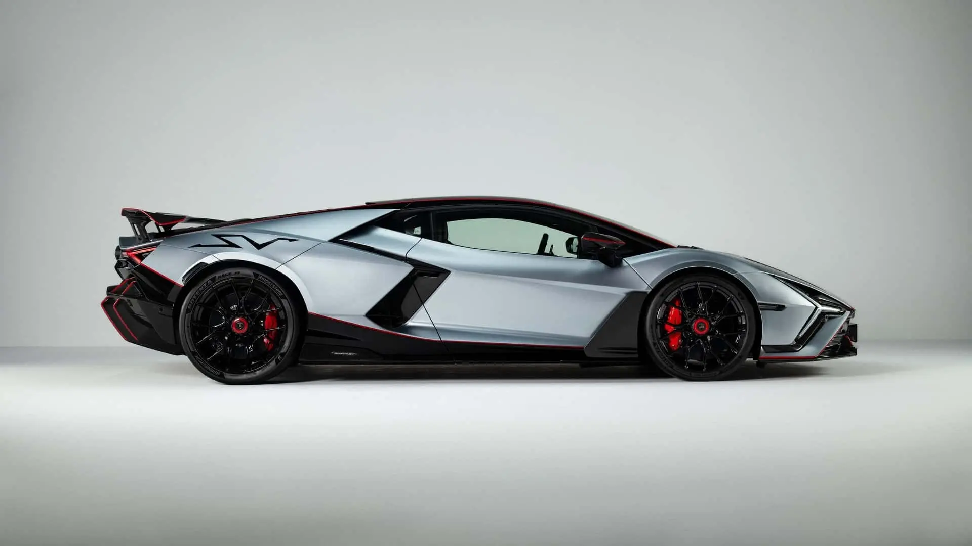 خودرو سوپر اسپرت لامبورگینی روئلتو (Lamborghini Revuelto) با رنگ نقره‌ای و خطوط قرمز