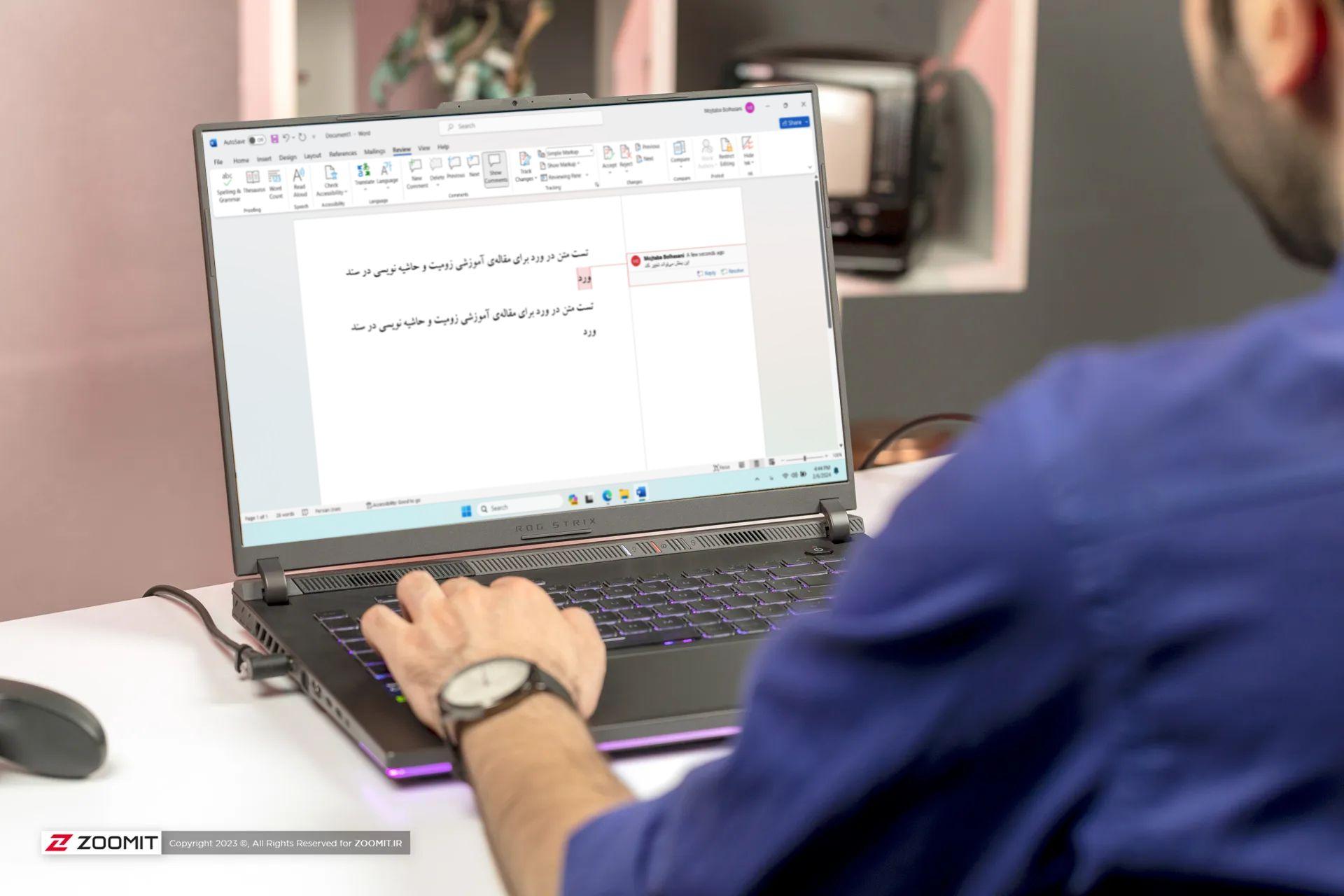 مرد جوان درحال کار با لپ تاپ و حاشیه نویسی در ورد