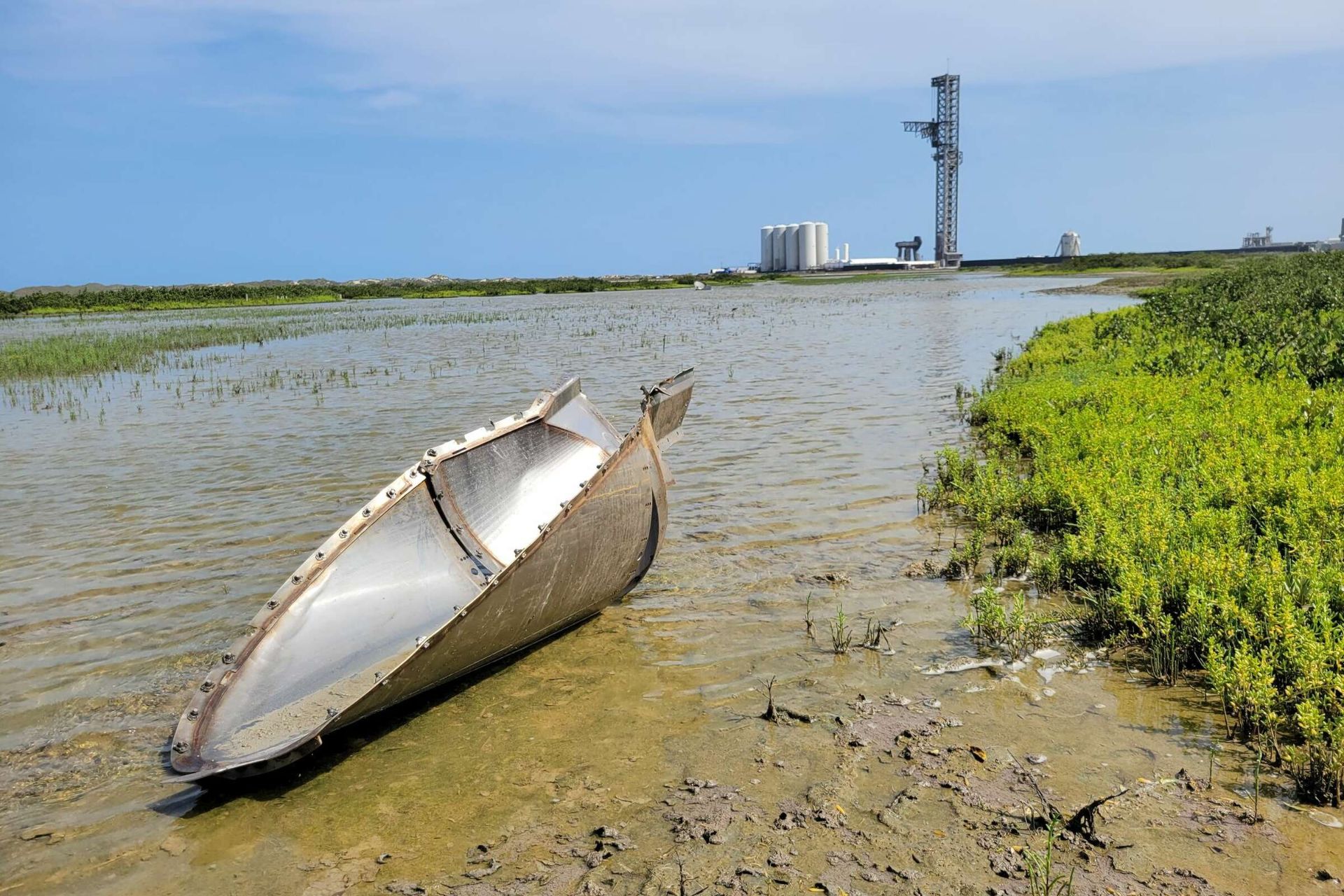 A large piece of metal on the ground about a kilometer away from the starship launch pad