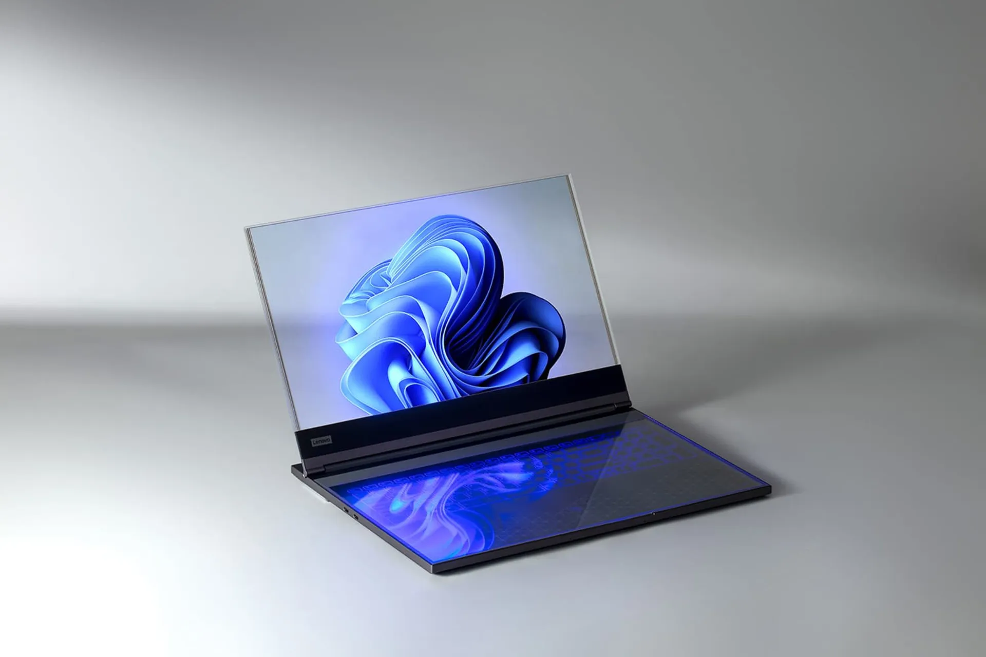لپ تاپ شفاف لنوو Lenovo از نمای جلو روی میز