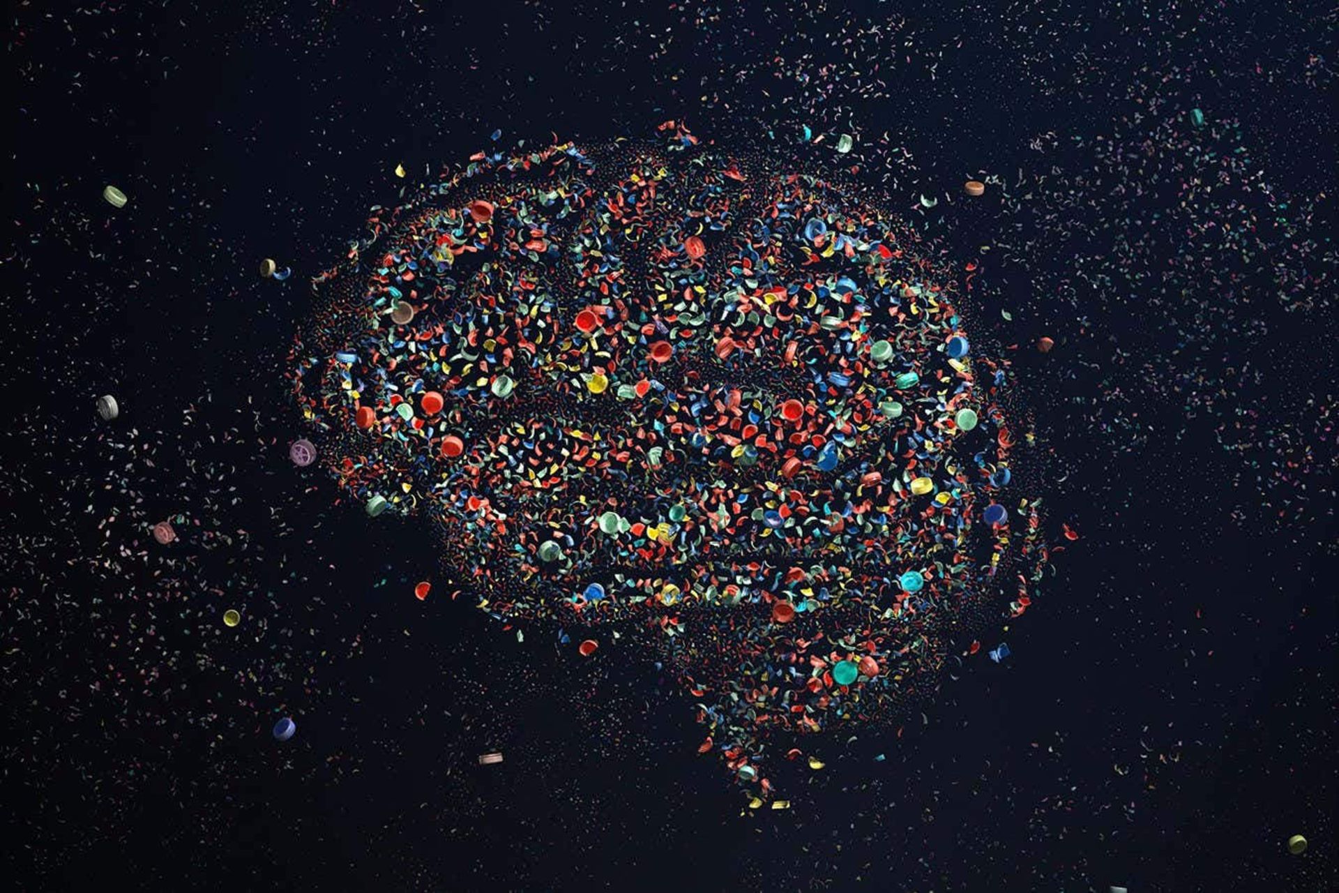 تصویرسازی مغز انسان ساخته شده از میکروپلاستیک‌های رنگی در زمینه سیاه