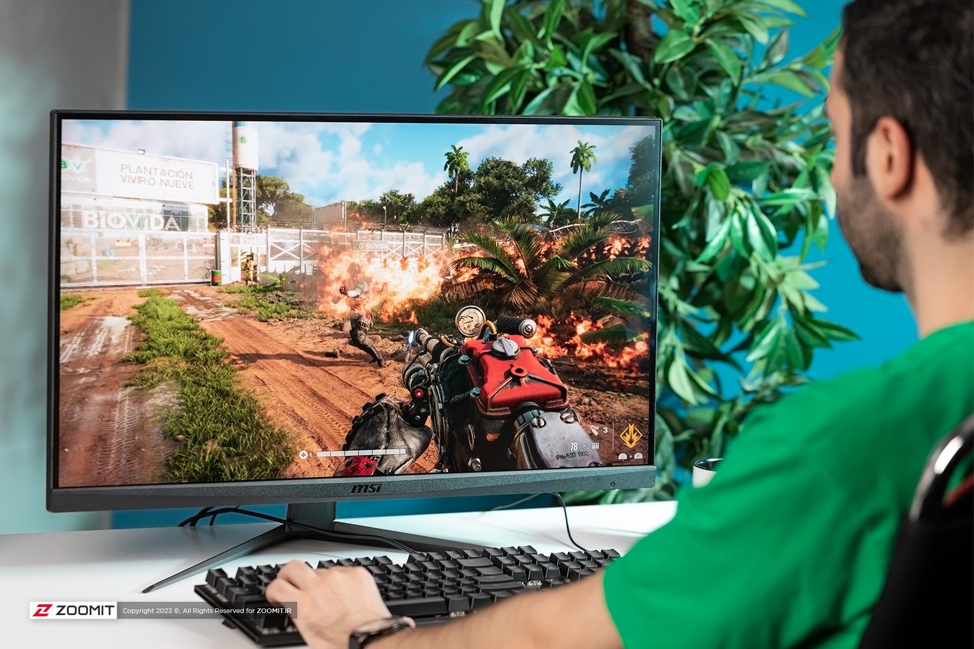 Young boy in green clothes playing with MSI G281UV monitor