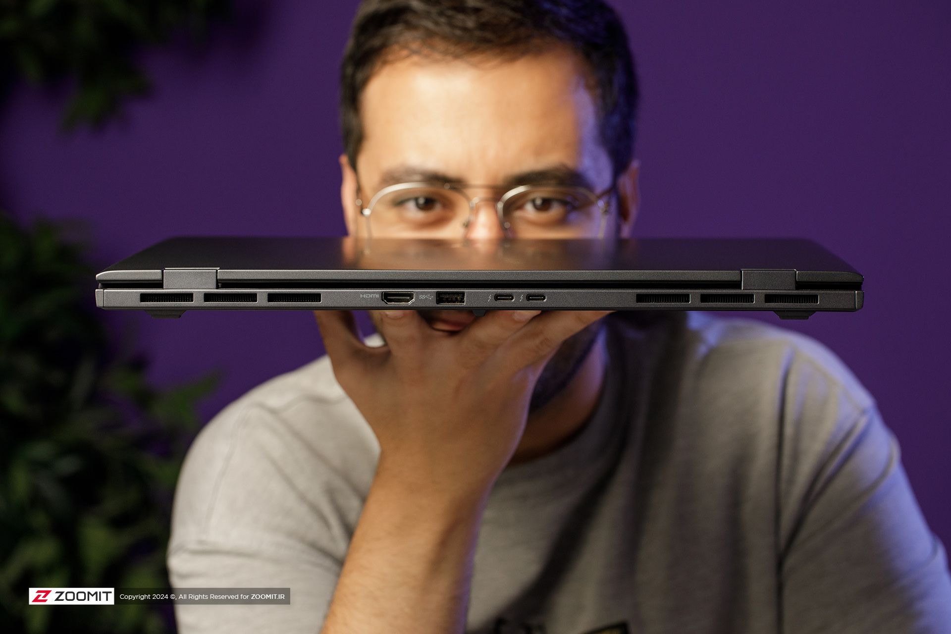 A thin laptop in a person's hand