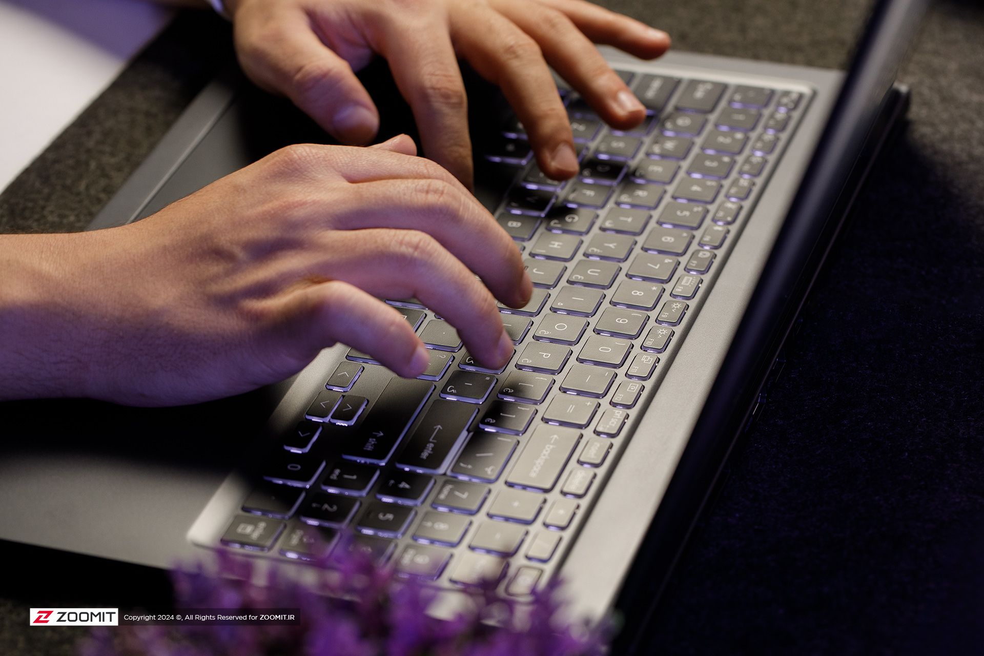 A person typing on a laptop