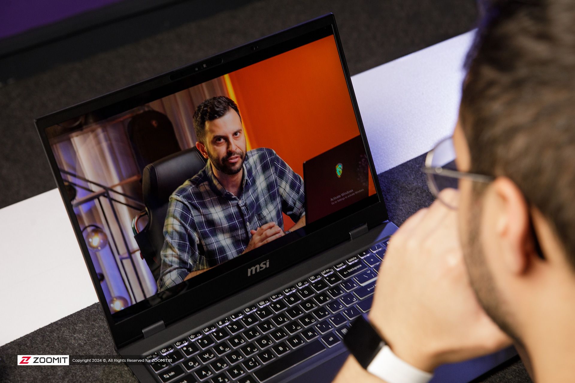 A person watching a movie on a laptop