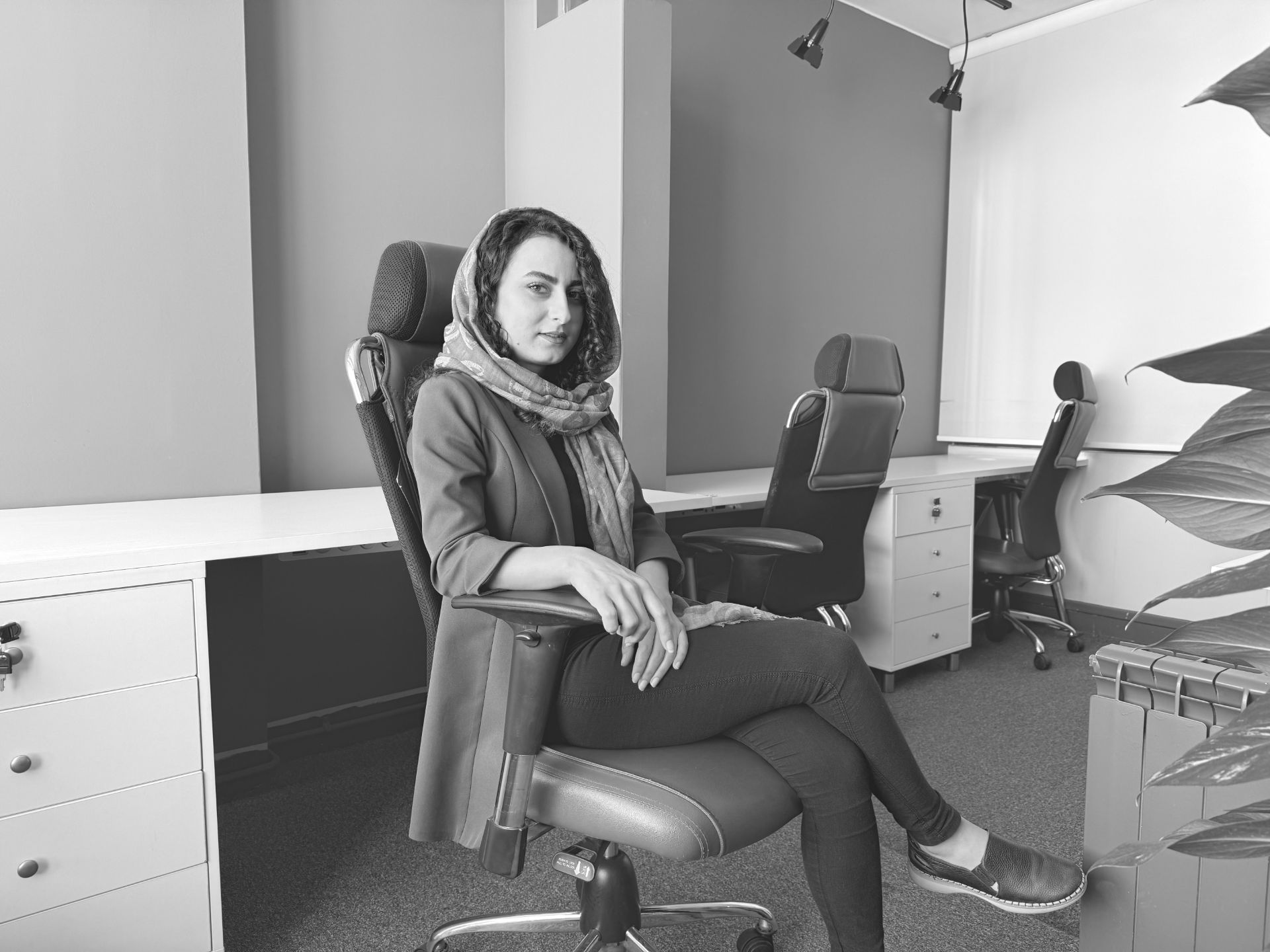 Kausar Nikomanesh, Zomit writer in the editorial office - Muted B&W iPhone 16 Pro photography style