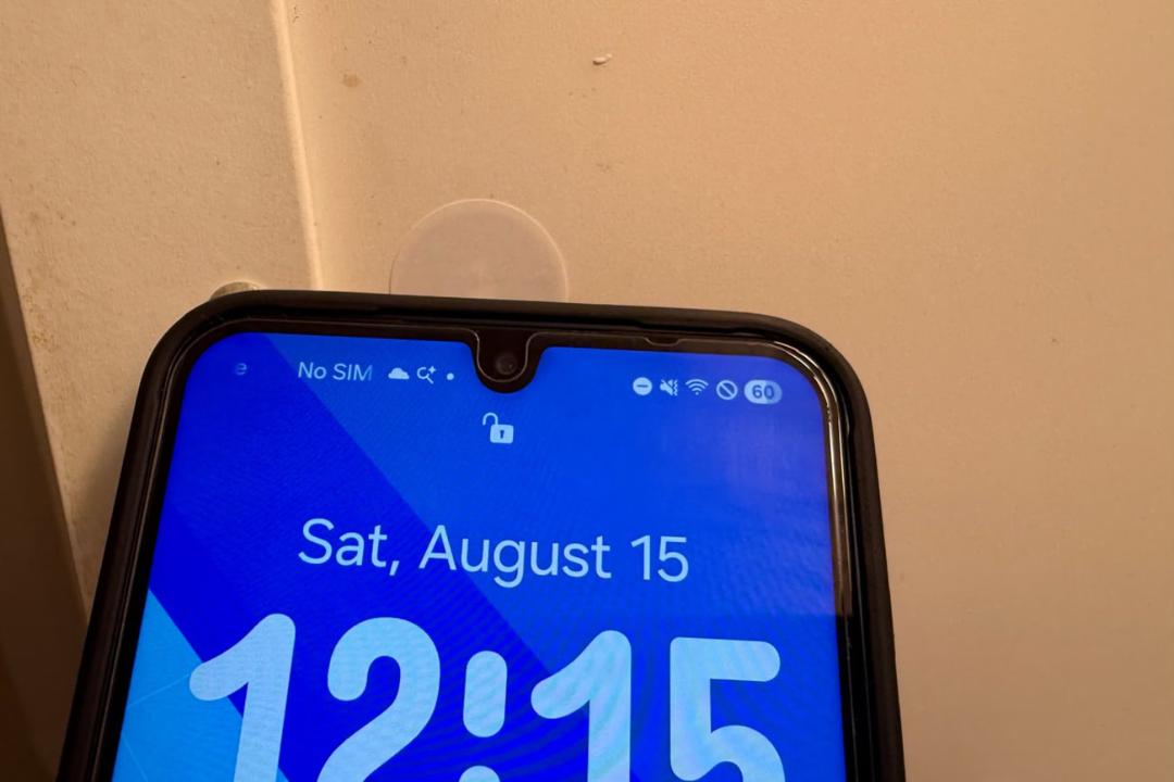 تگ NFC چسبانده شده روی دیوار در کنار صفحه نمایش گوشی هوشمند