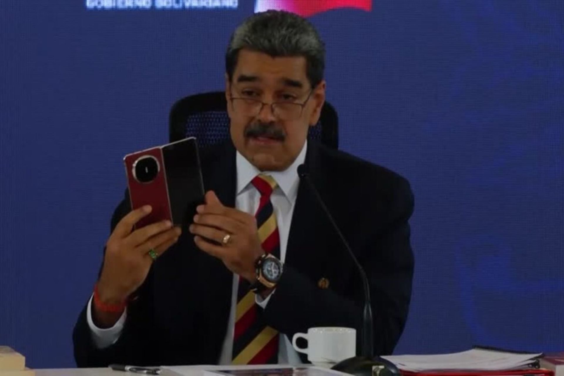 یک مرد میان‌سال در حال نمایش گوشی هواوی