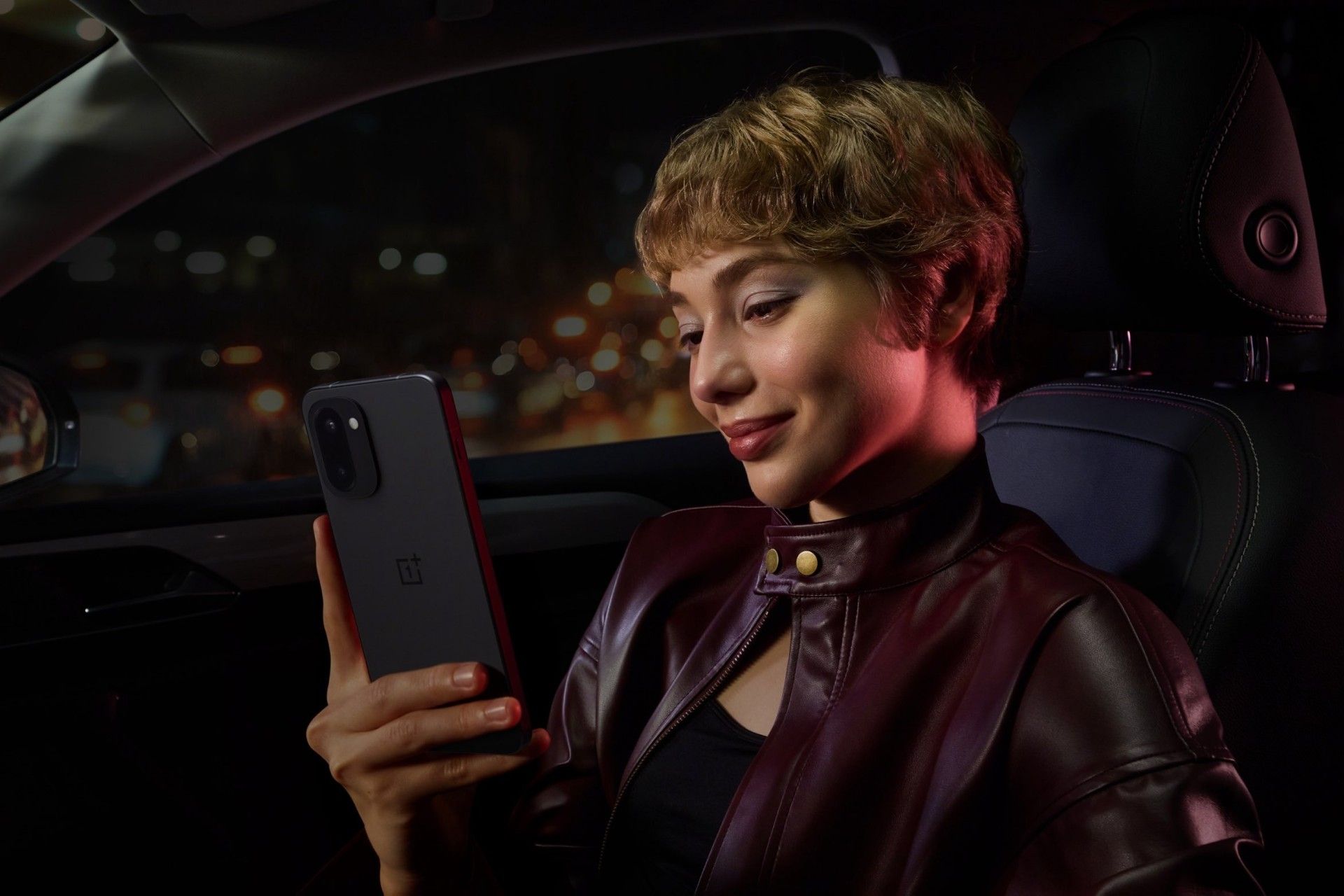 پنل پشت گوشی وان‌پلاس 15R در دست یک زن جوان داخل خودرو