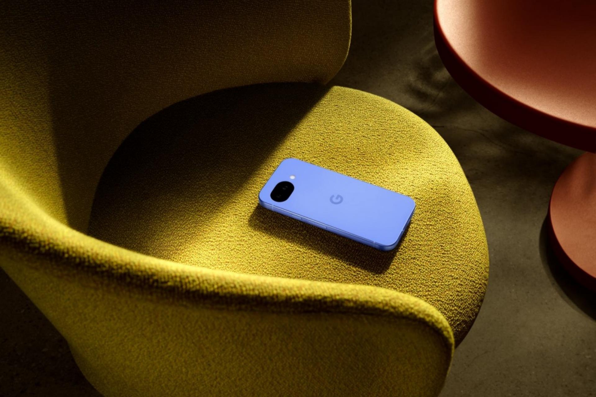 گوشی پیکسل 10a در رنگ آبی روی صندلی زرد رنگ