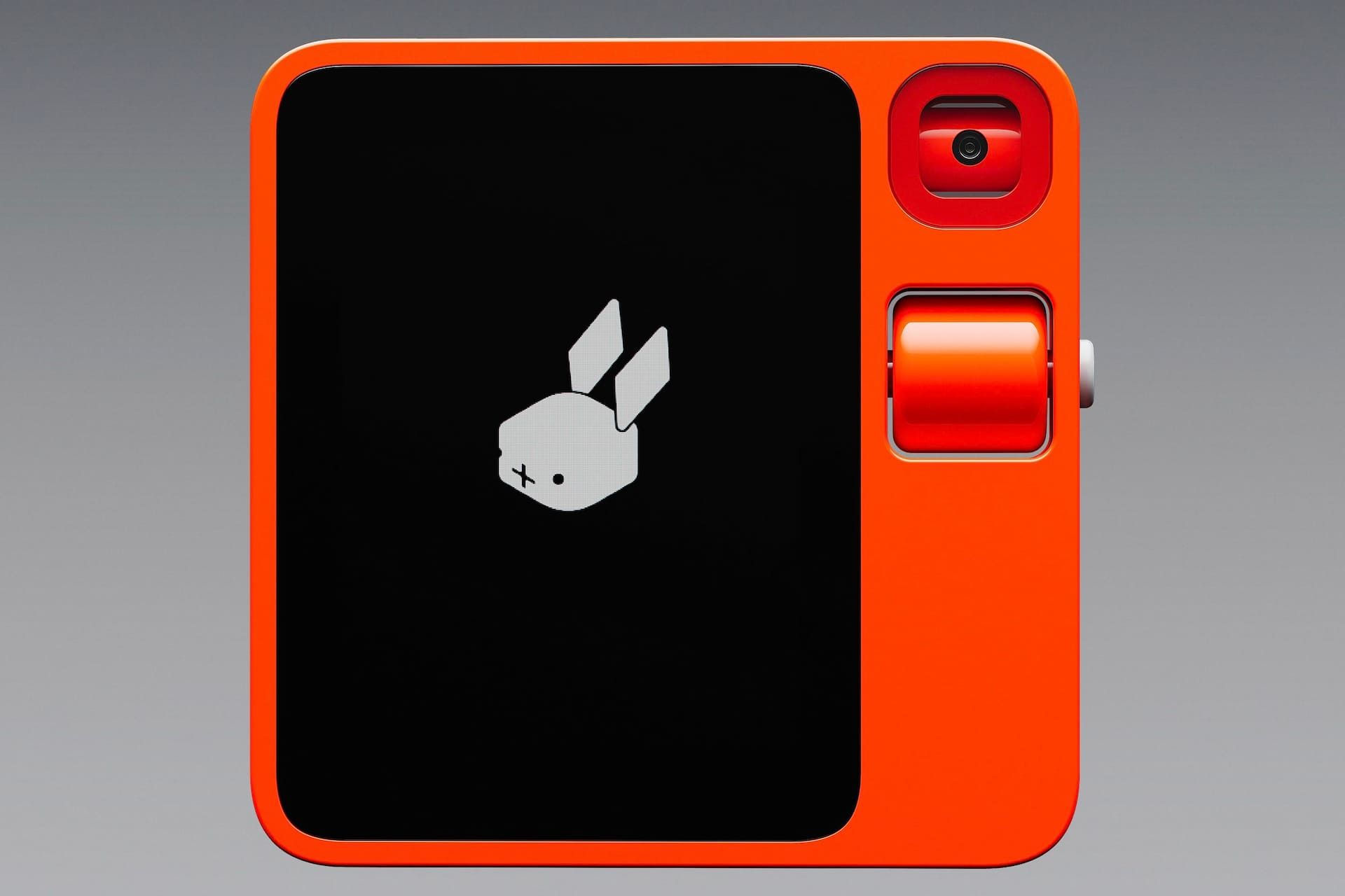 گجت نارنجی رنگ Rabbit R1 با پس‌زمینه خاکستری رنگ