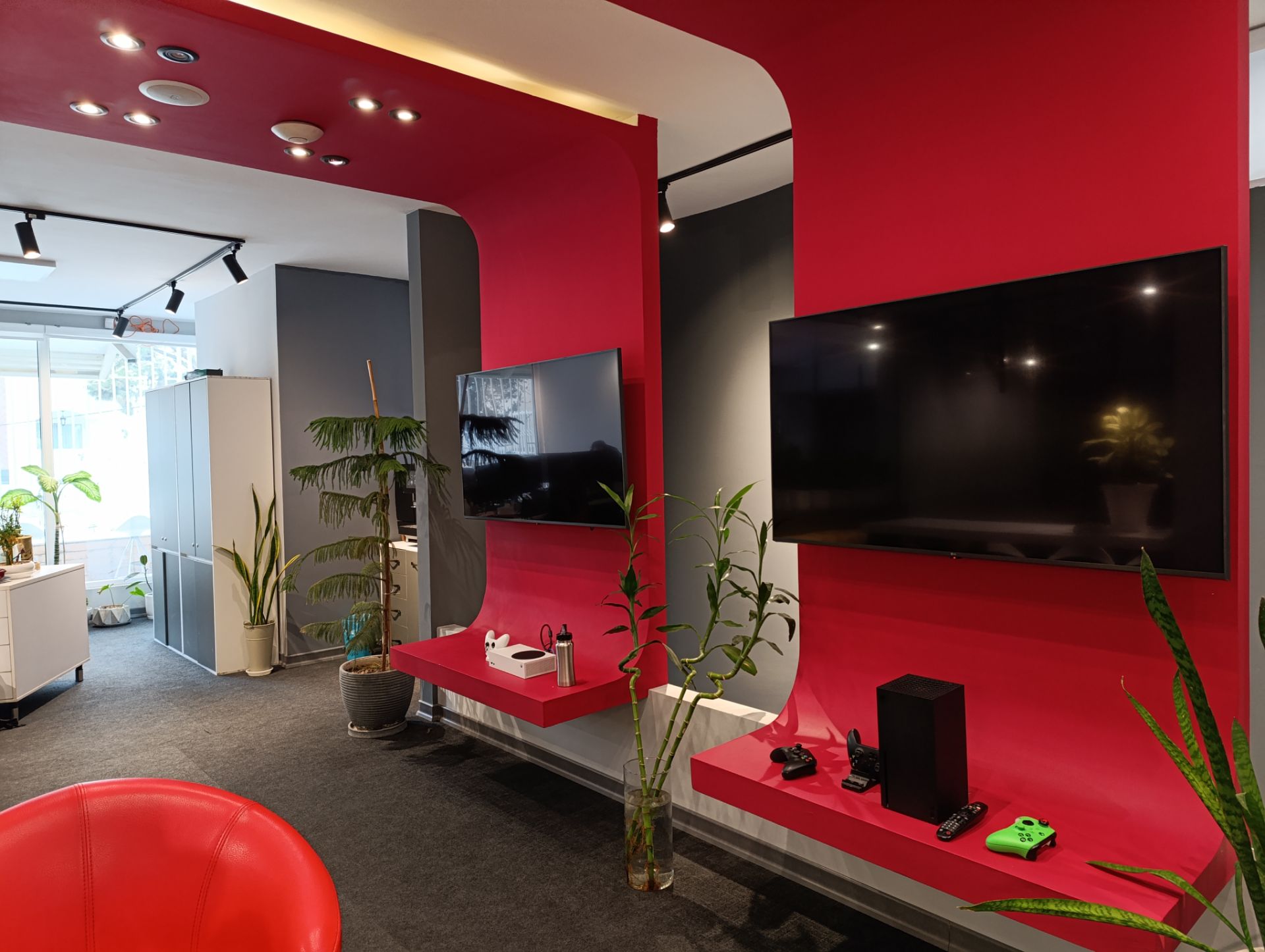 نمونه عکس ردمی نوت ۱۳ پرو 4G از محیط داخلی یک دفتر کار با دیوار قرمز و تلویزیون روی دیوار