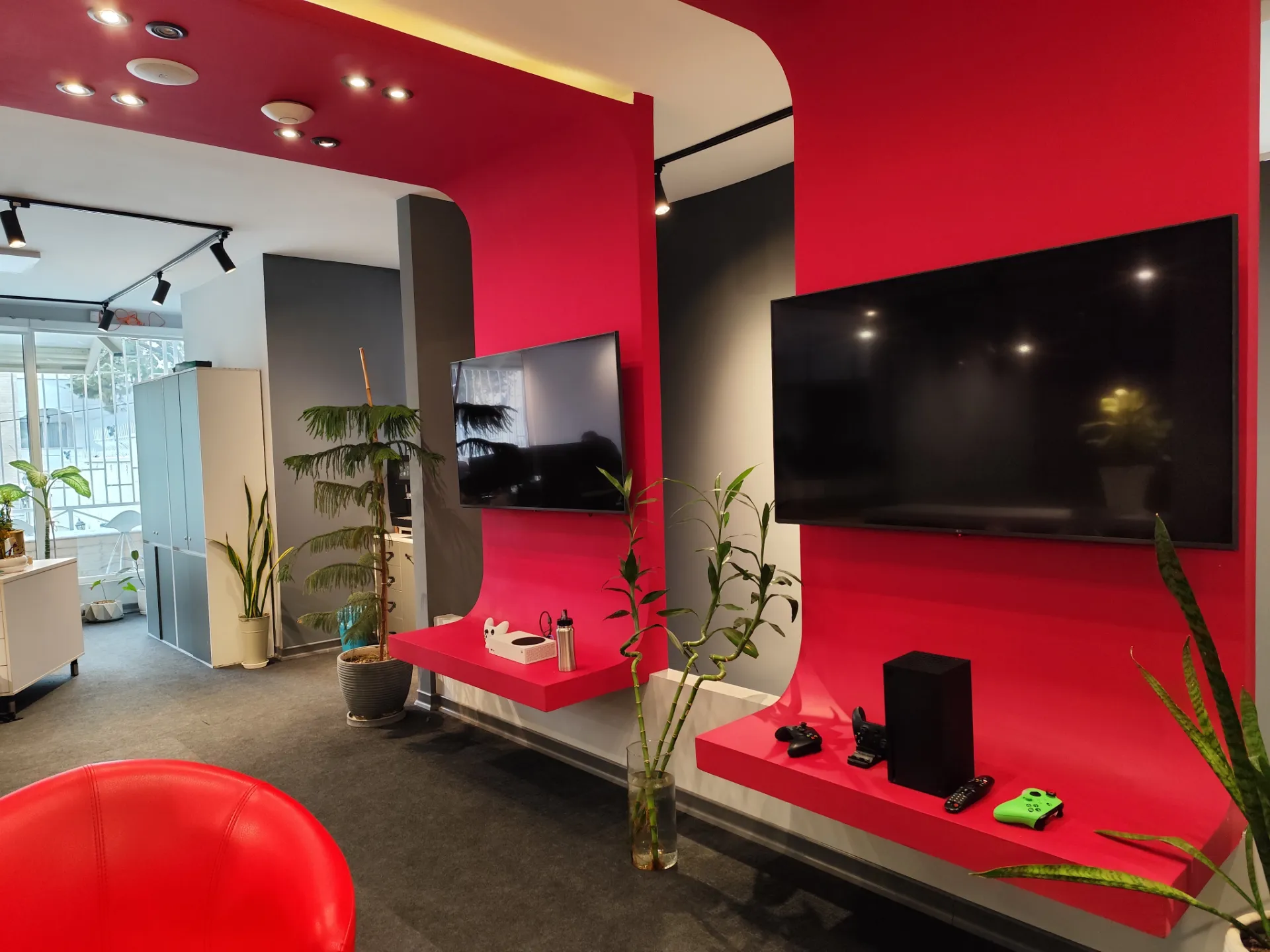 نمونه عکس ردمی نوت ۱۳ پرو 5G از محیط داخلی یک دفتر کار با دیوار قرمز و تلویزیون روی دیوار